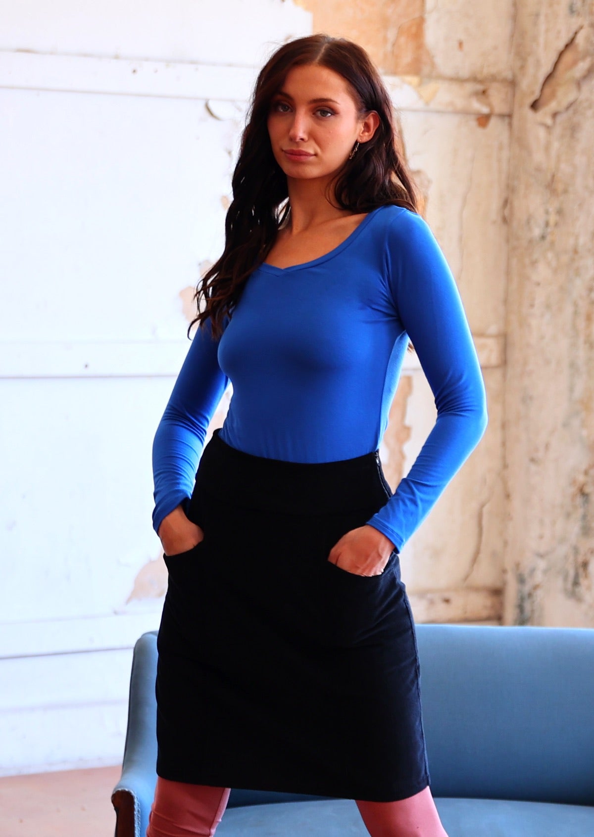 woman wearing black cotton corduroy skirt with blue long sleeve top
