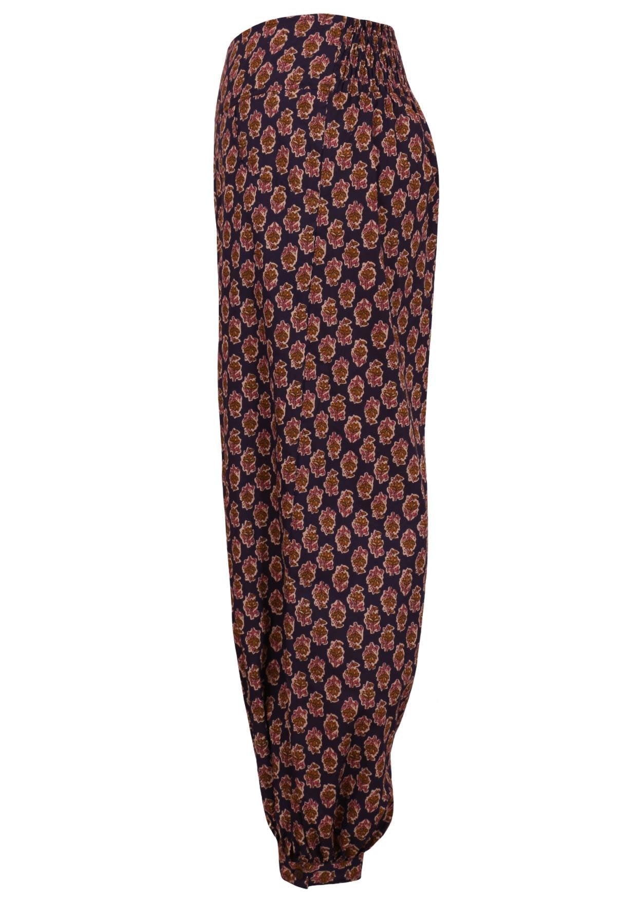 100% cotton pants in floral printed design on dark purple base with wide waistband and pockets.