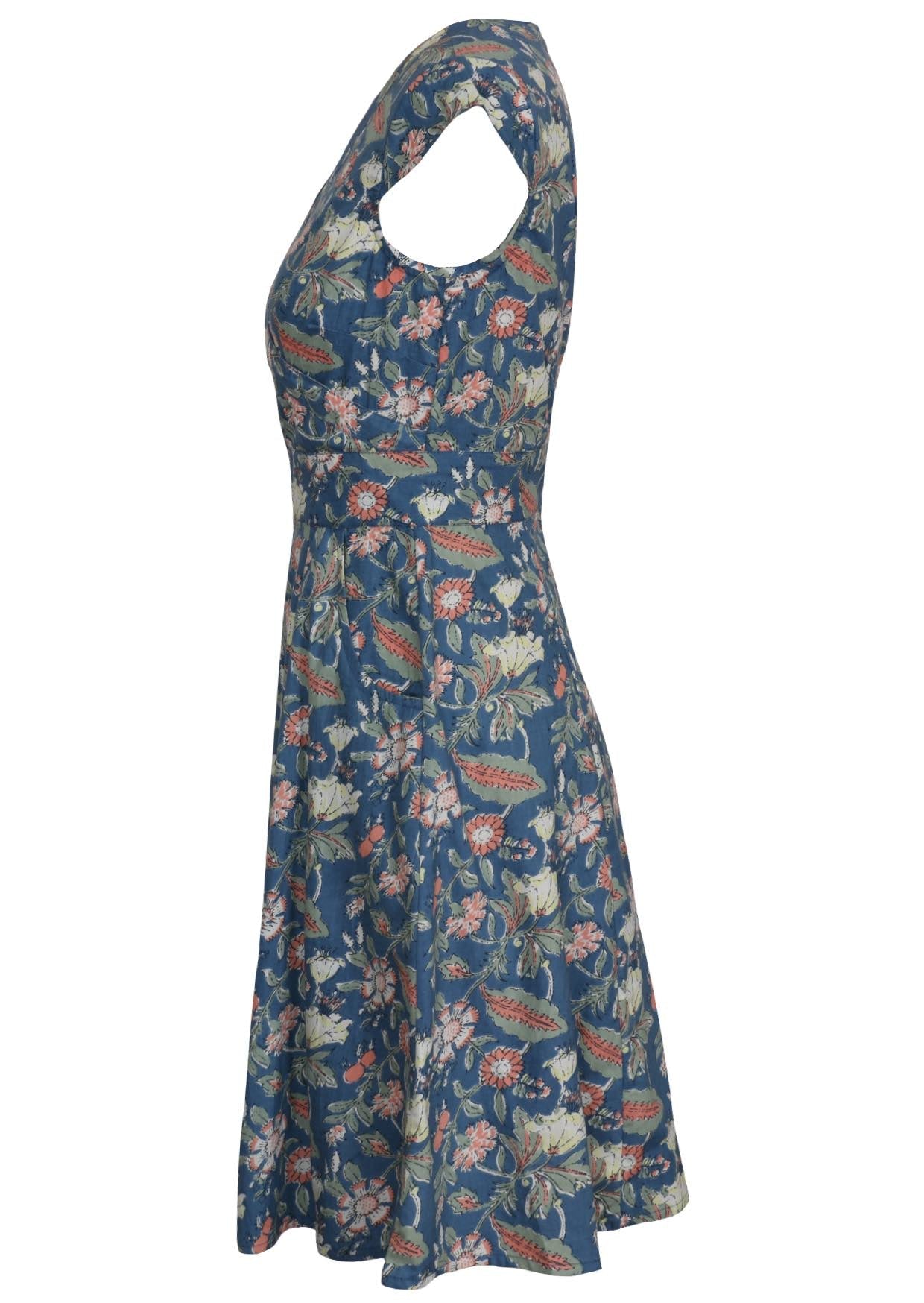 Side view of knee length retro cotton dress with cap sleeves and pockets.