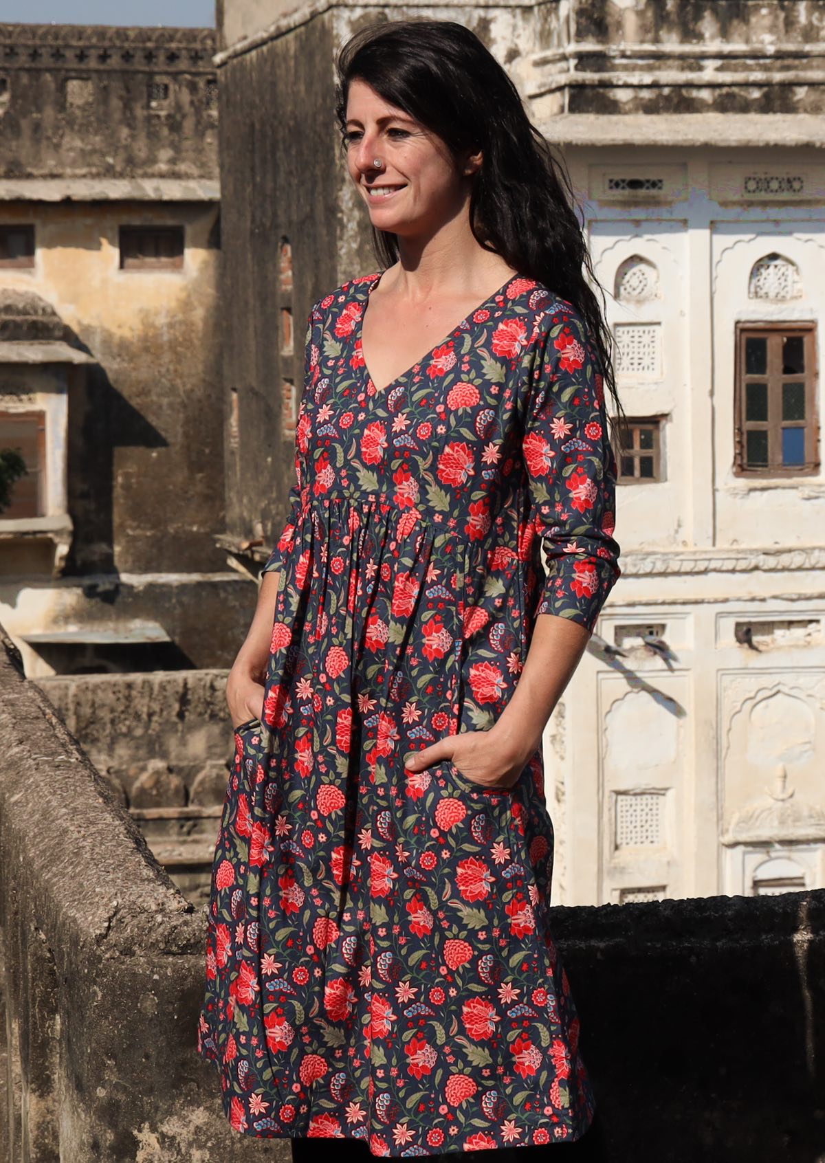 Woman wears relaxed fit cotton 3/4 sleeve V-neckline over the knee length dress