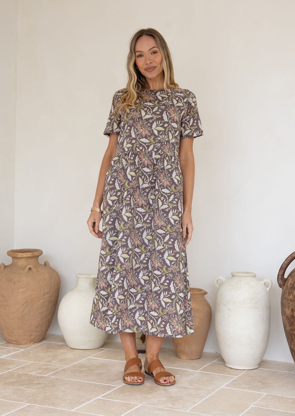 Model wearing a relaxed fit mid length 100% cotton dress with boat neckline, T shirt sleeves and pockets.
