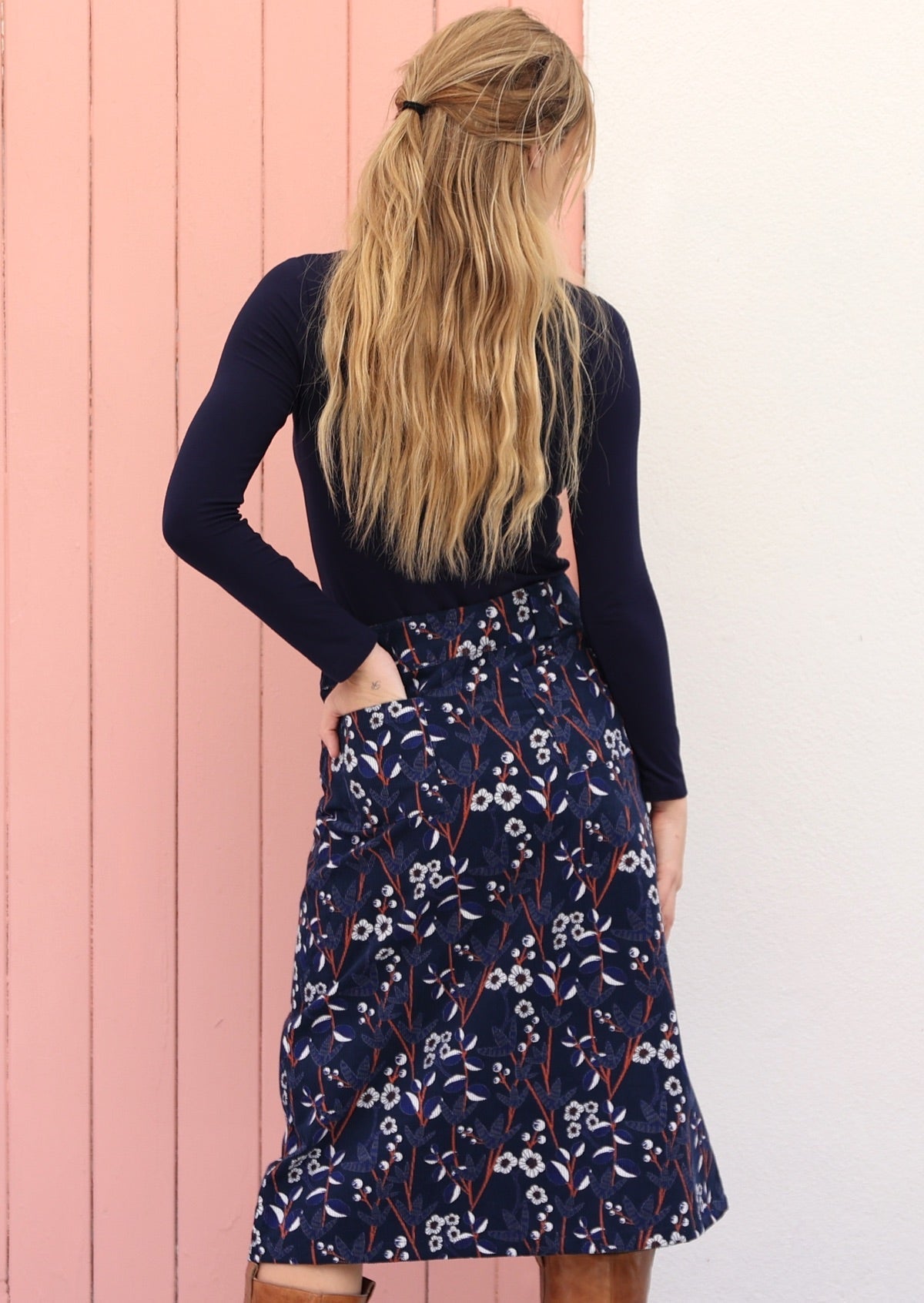 Back image of a model wearing a 100% cotton cord skirt with belt loop and back pockets