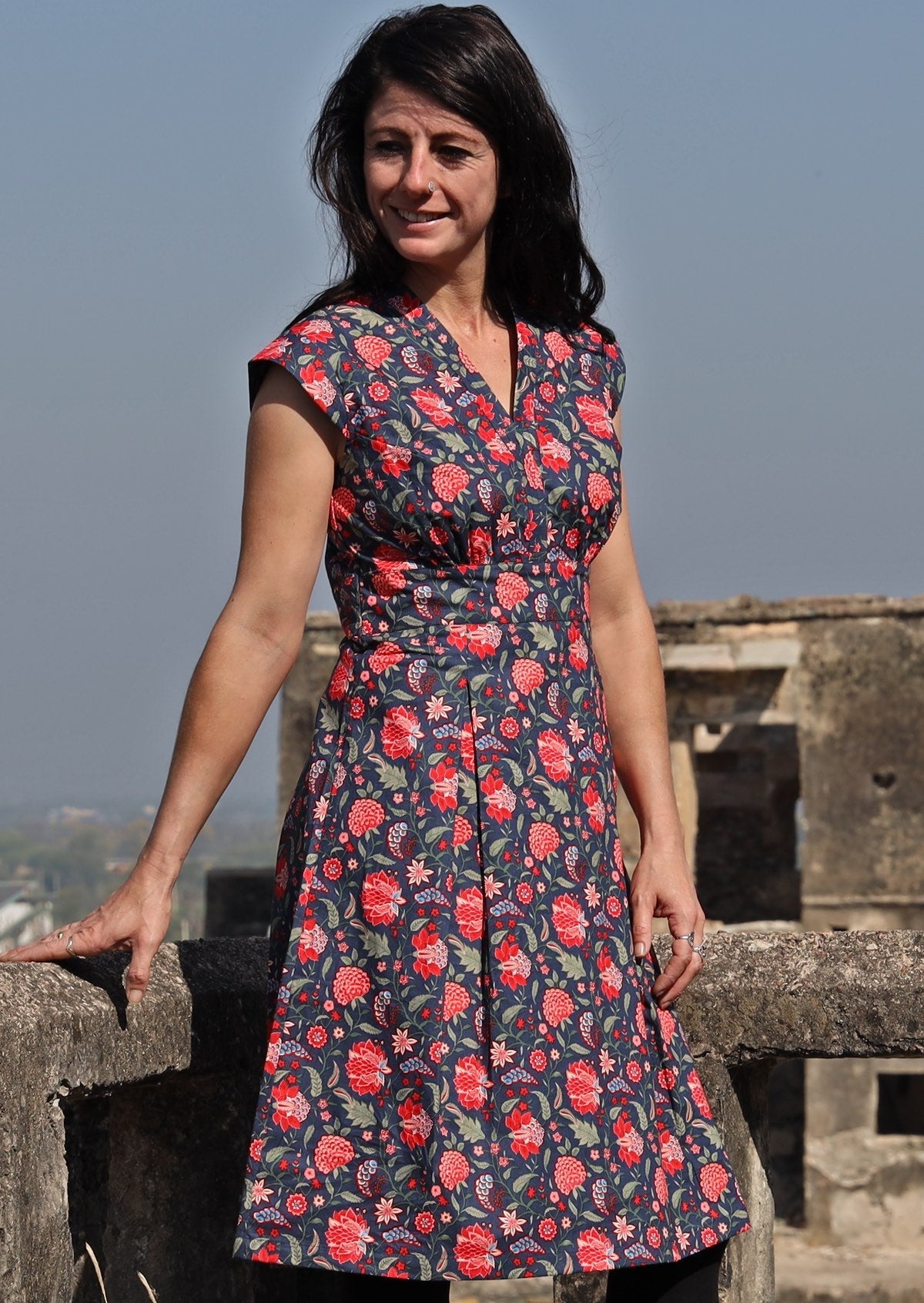 Model wearing deep navy blue based floral cotton retro style dress