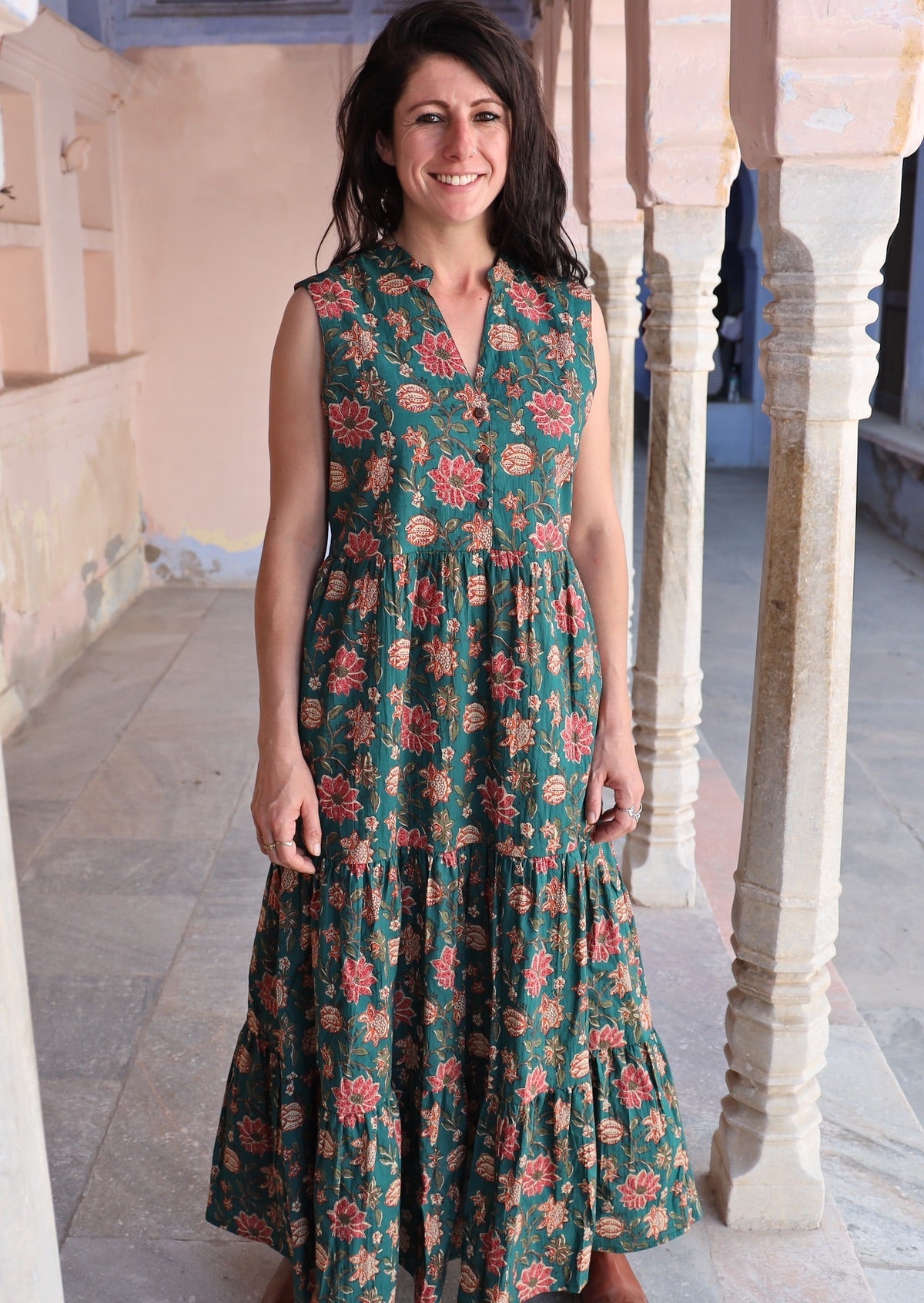 Model wears 3 tiered cotton maxi dress without sleeves and buttoned bodice.