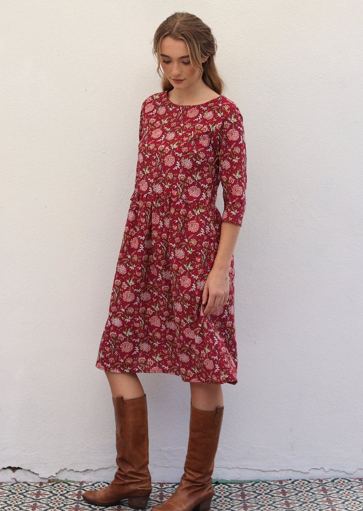 Model wearing relaxed fit cotton dress sitting just below the knee length with wide round neckline.