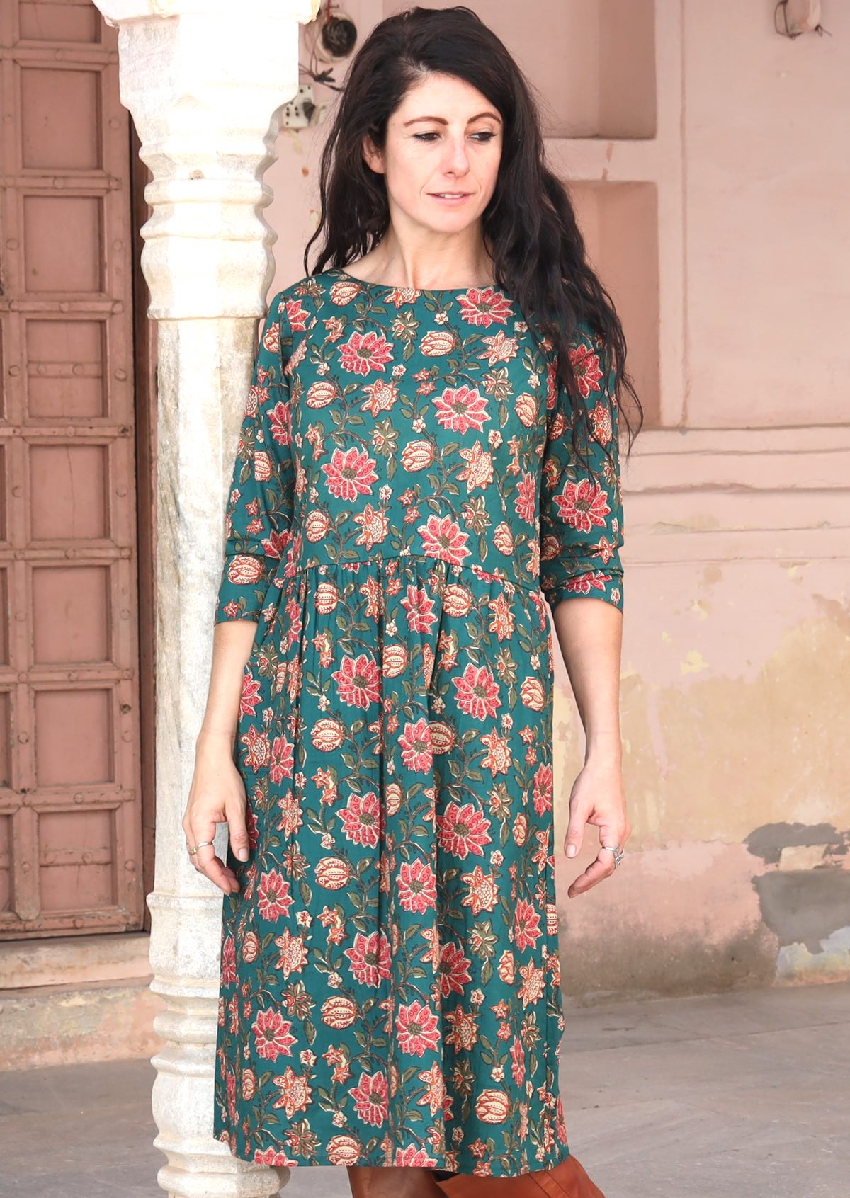 Model wears a loose fitted dark green cotton dress with 3/4 sleeves, lining and pockets.