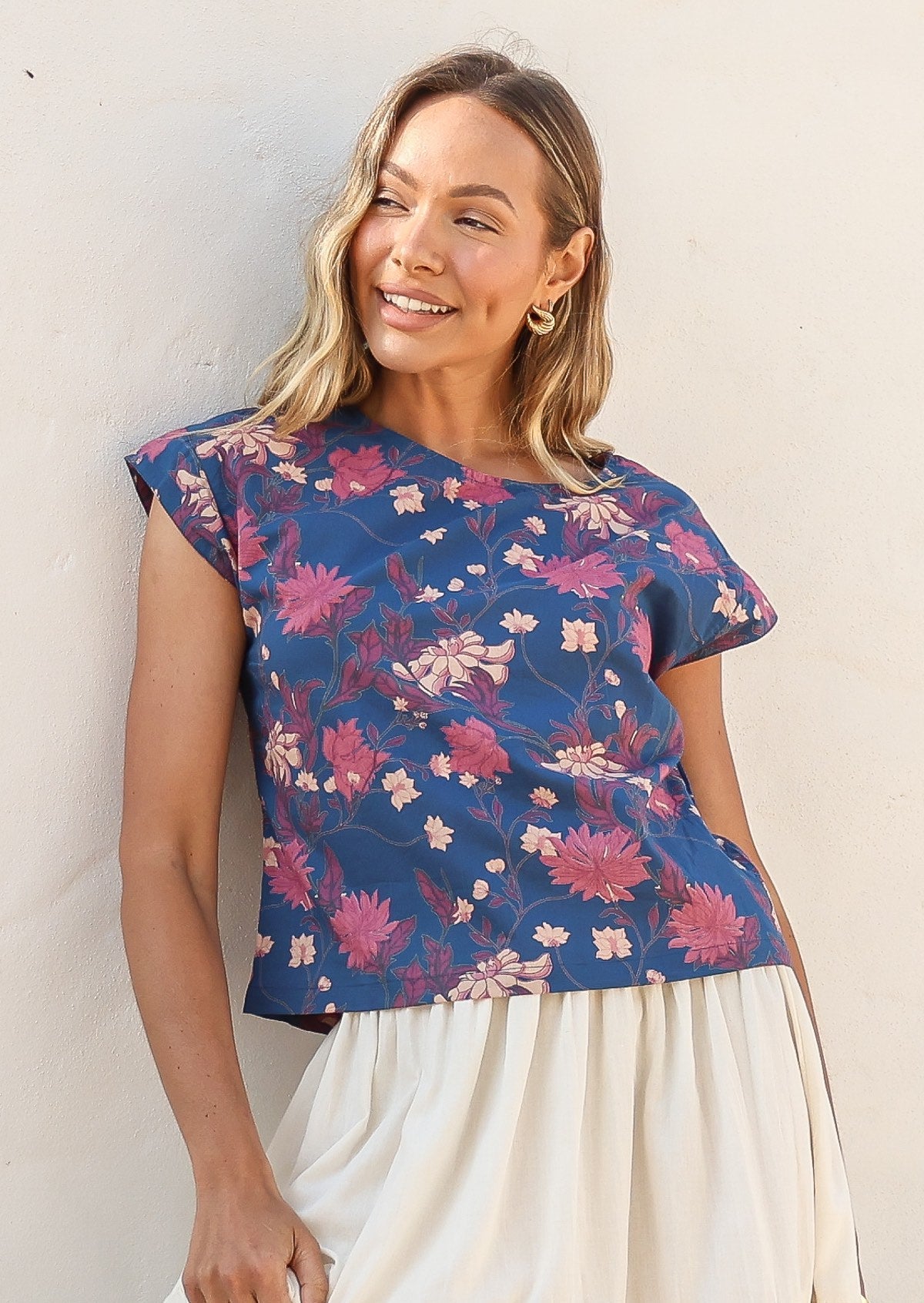 Model wears 100% cotton short sleeved top with round neckline in blue based floral print