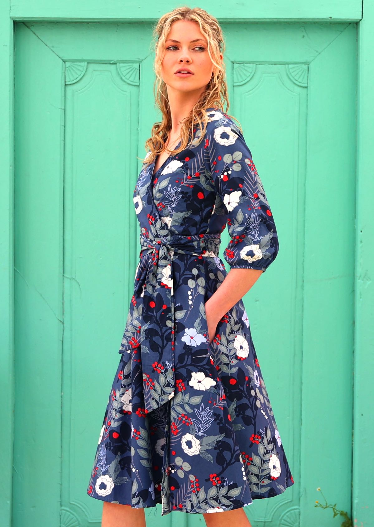 woman with blonde hair in 100% cotton wrap dress in blue with white flowers