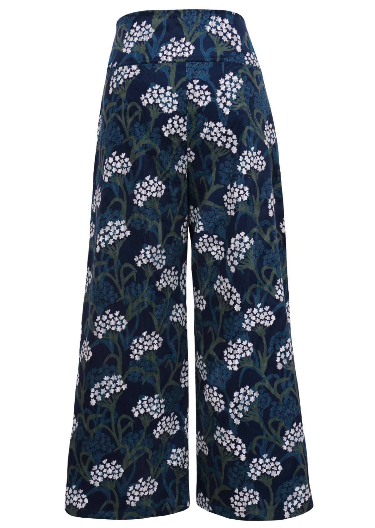 Blue, green and white floral print on a dark blue base cotton corduroy pants with a wide waistband