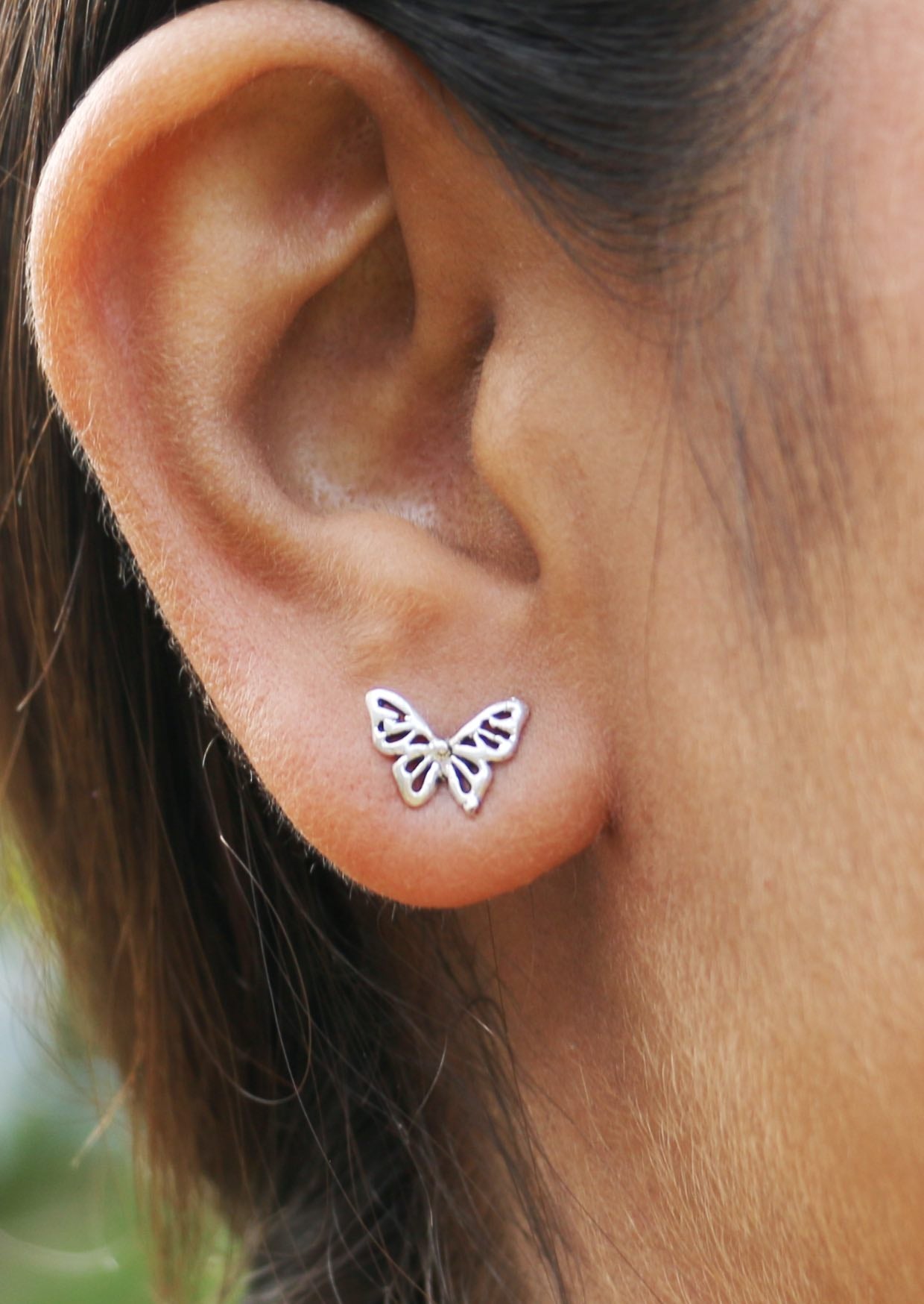 Ethereal butterfly silver studs with intricate cutout details and butterfly backs