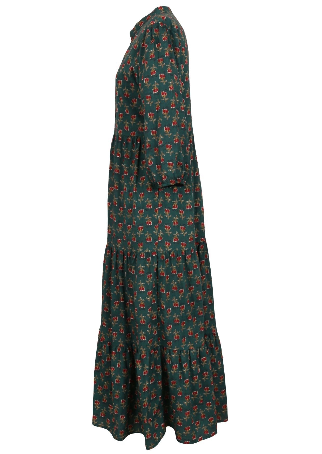 Side view of a full length maxi dress with 3 tiered flowy skirt, mandarin collar, buttoned bodice and pockets