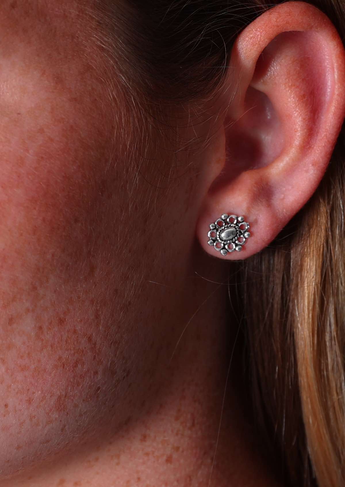 Close up of Gilded Silver Stud earring in models ear