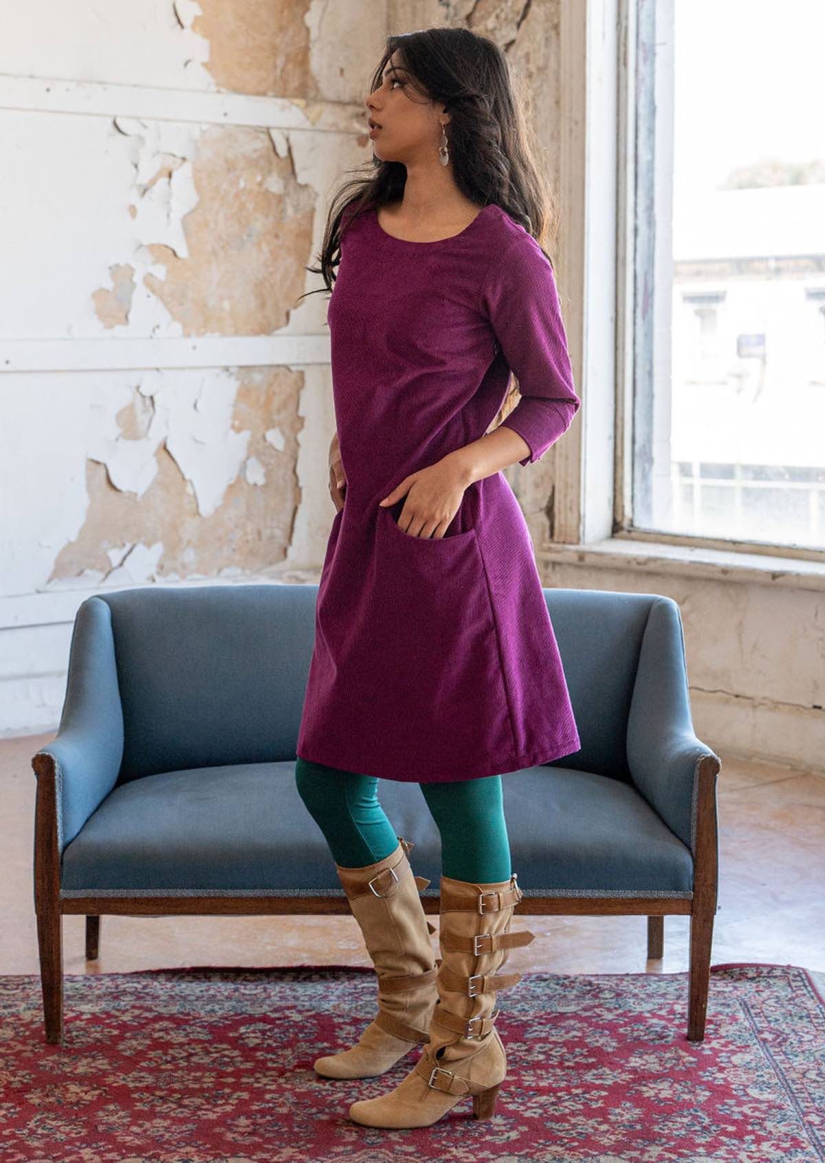Woman standing wearing 100% cotton 3/4 sleeve corduroy shift dress with hands in pockets