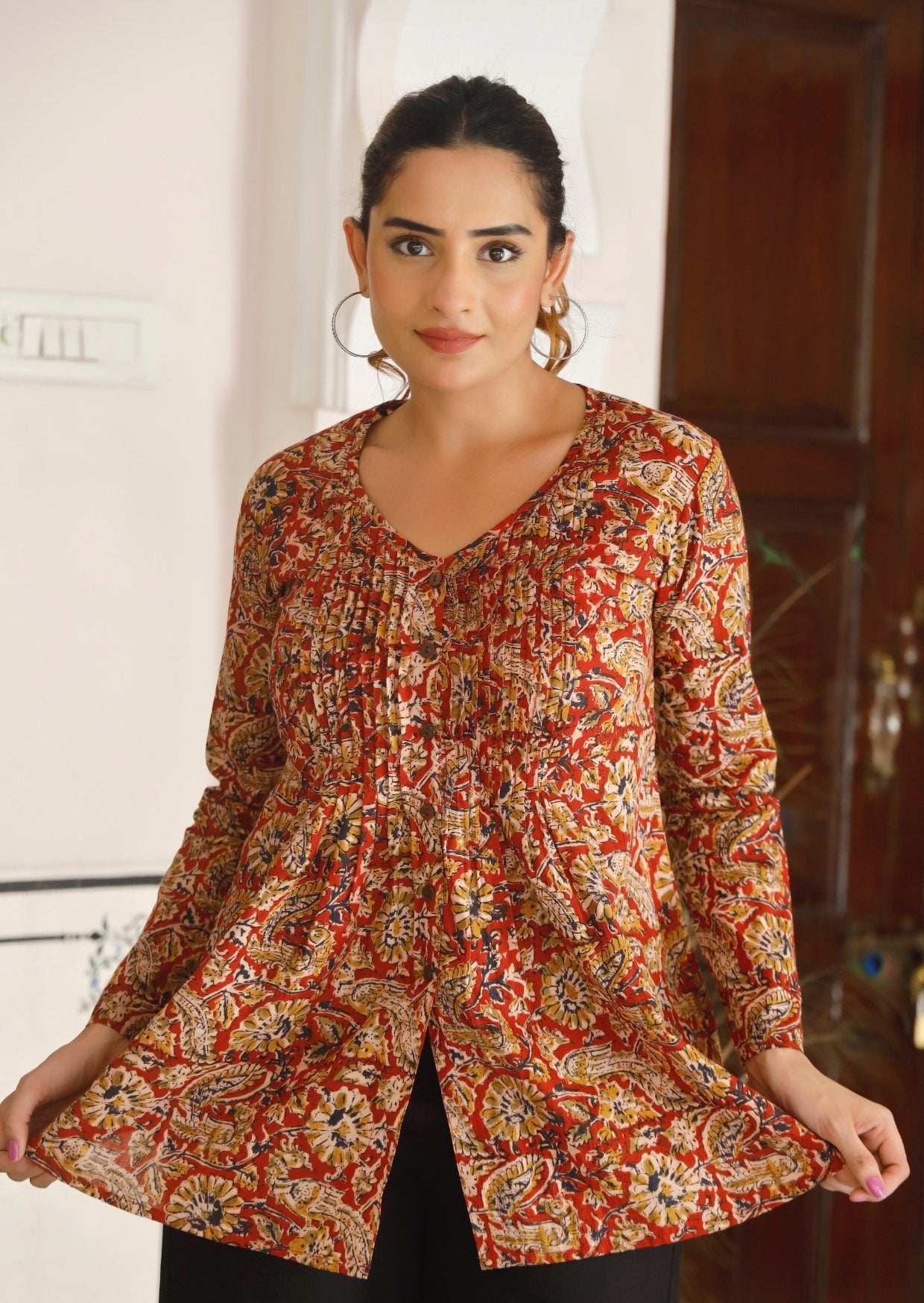 Woman wears cotton full sleeve top with V neckline and pink tuck in front and back