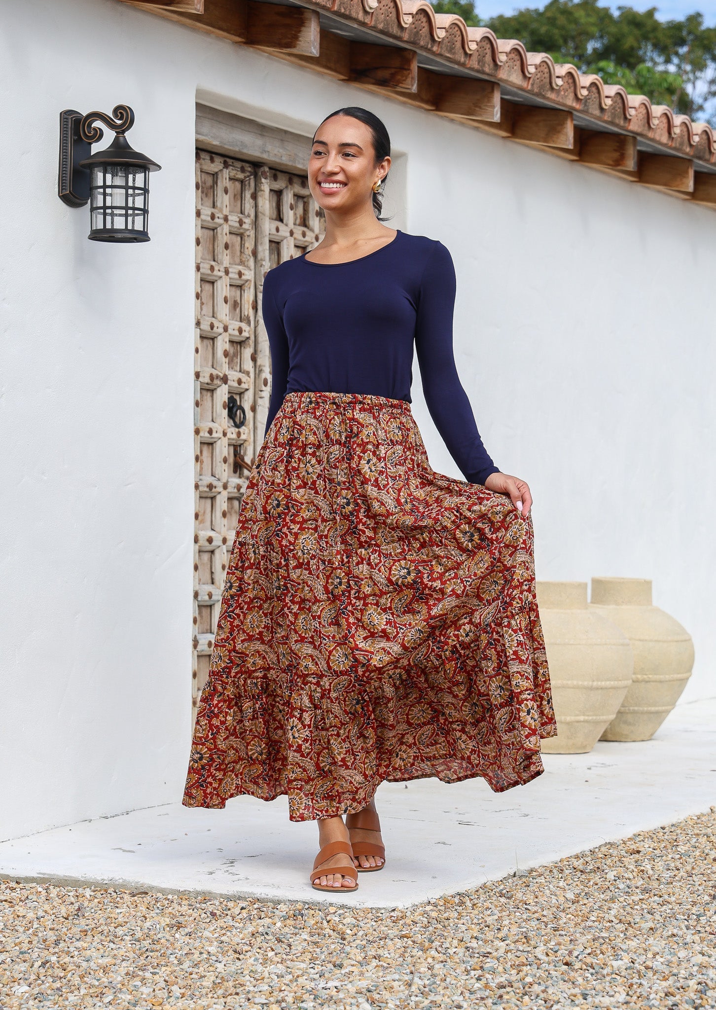Model wears crinkled cotton skirt with elastic waist and drawstring, paired with long sleeve stretch navy blue top.