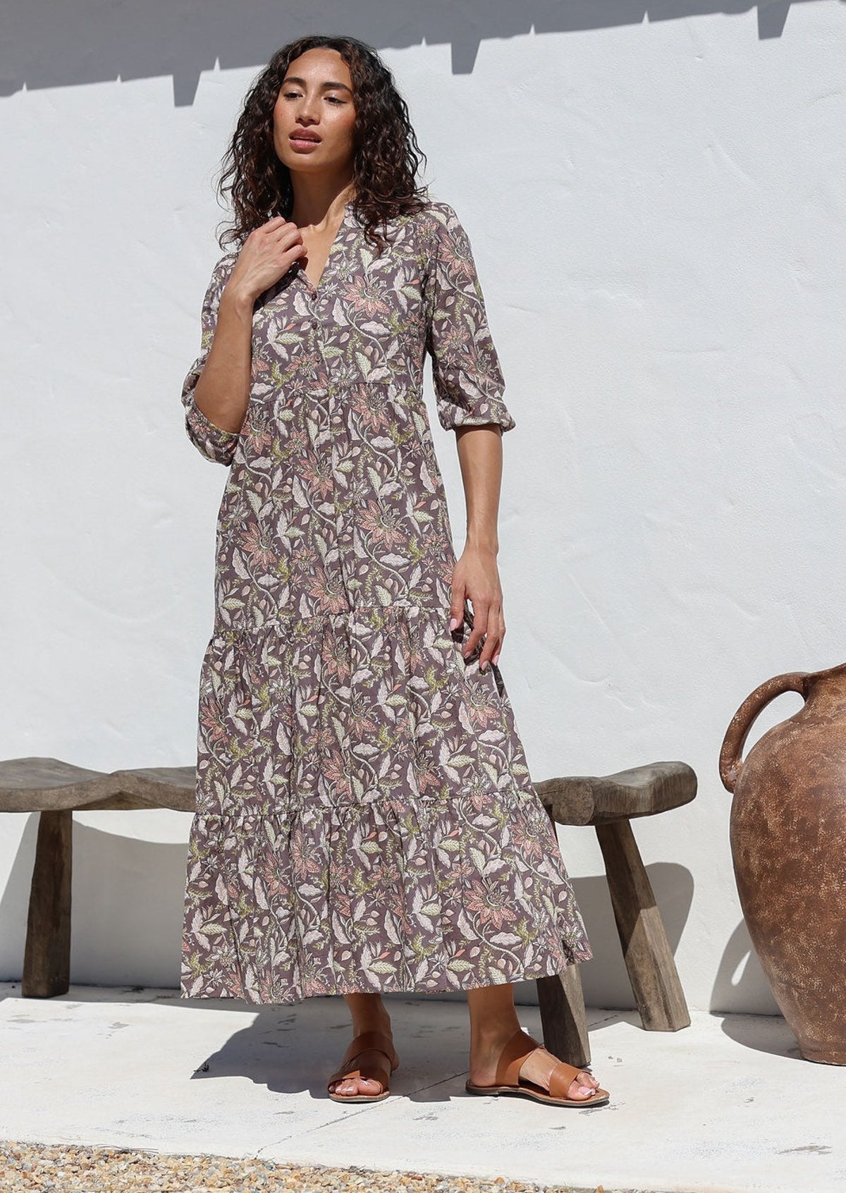 Woman wearing relaxed fit floral printed cotton maxi dress in grey with 3/4 sleeves, pockets and three tiered skirt