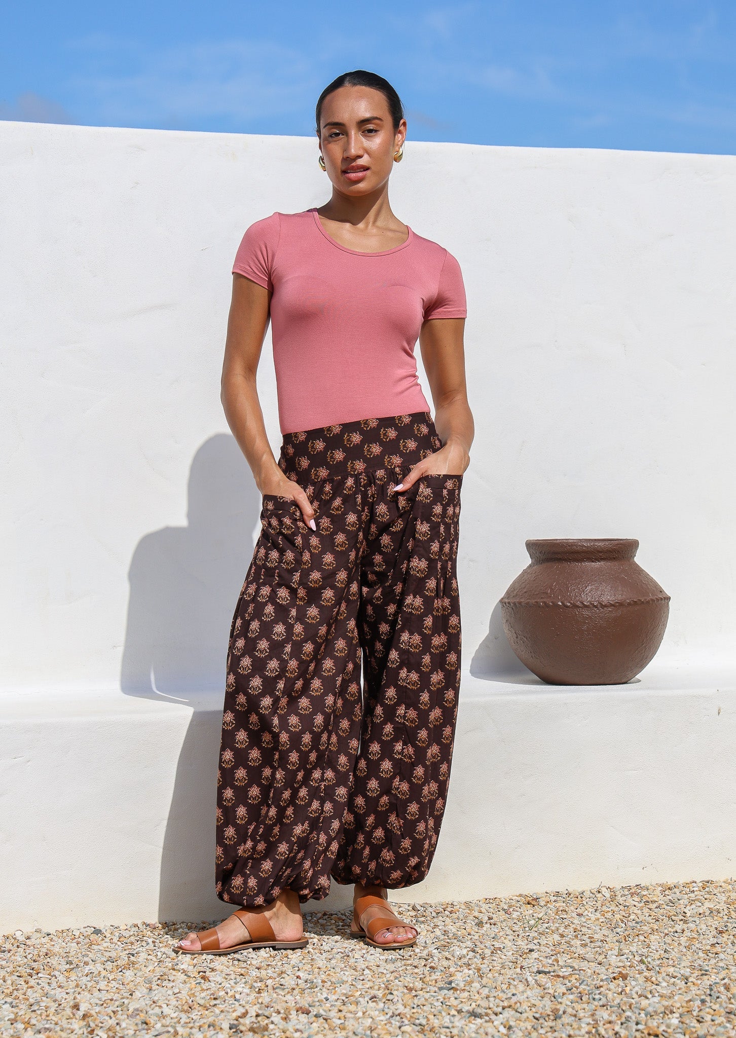 Model wears 100% cotton harem pants with elasticated ankles, wide waistband and hands in deep pockets.