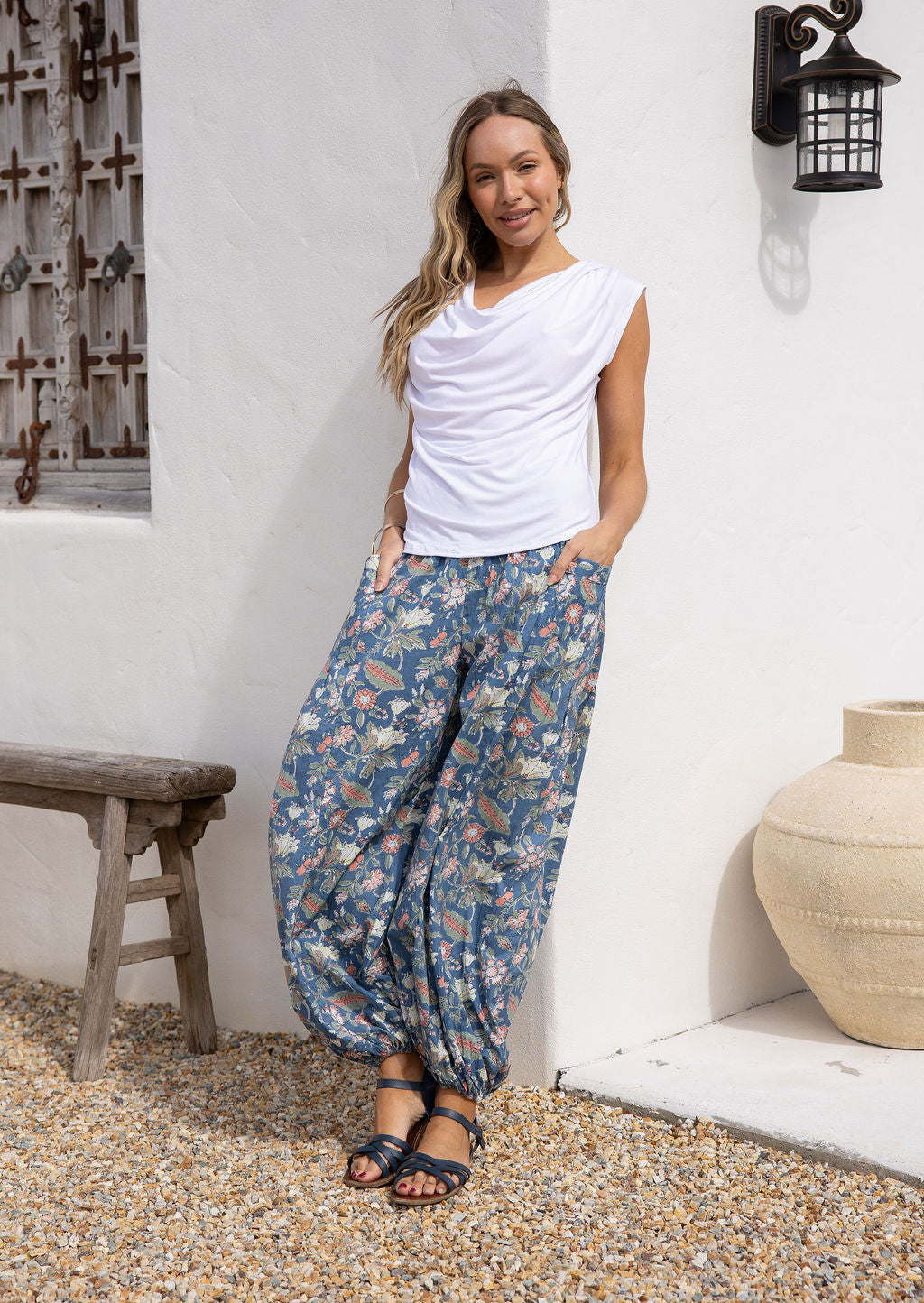 Model poses in lightweight 100% cotton harem pants with elastic-backed wide waistband, elasticated ankles and pockets.