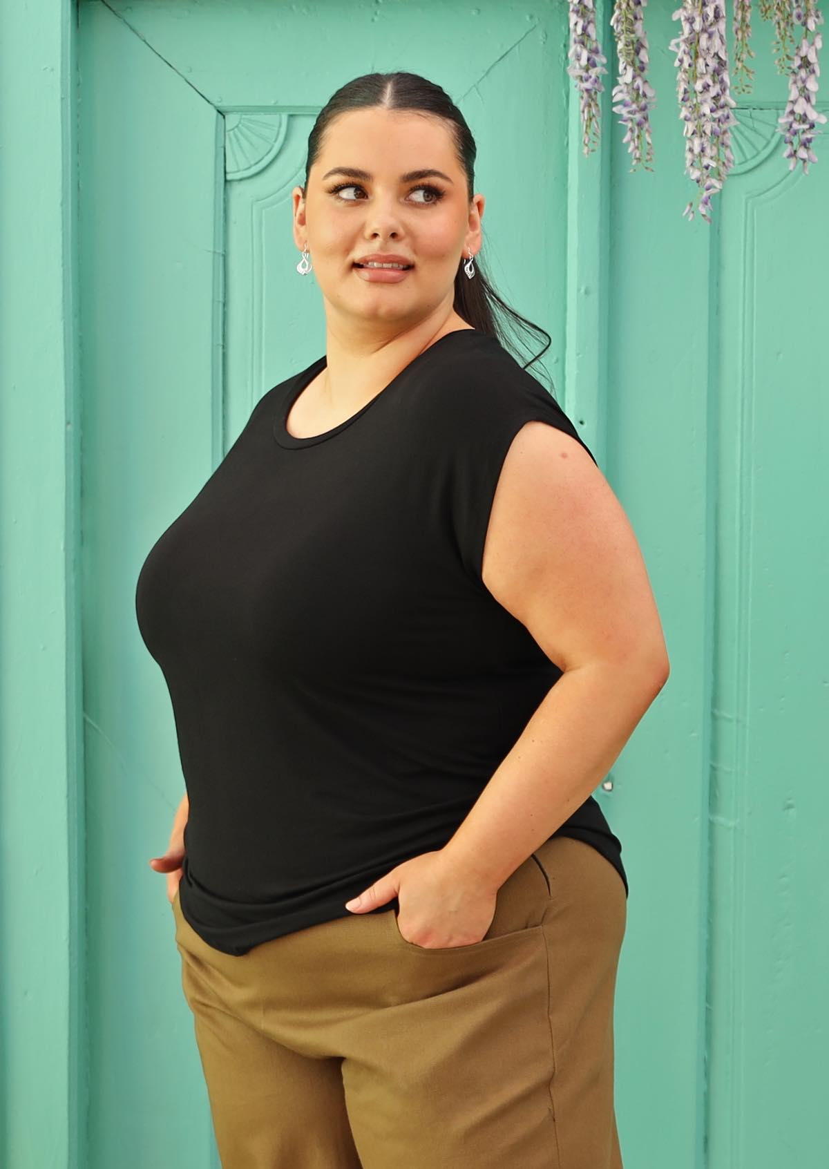 Plus sized model wearing a classic black rayon t-shirt.