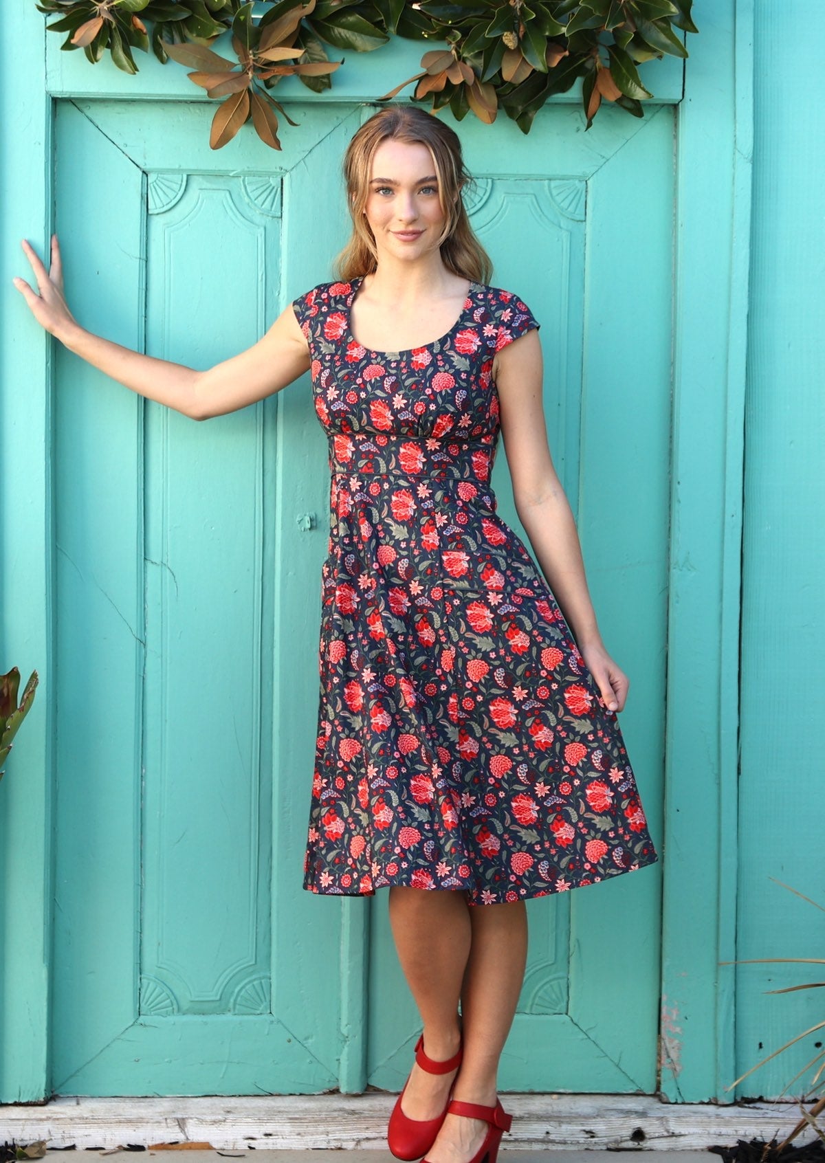 Model wearing retro style cotton dress with scoop neck and pockets.