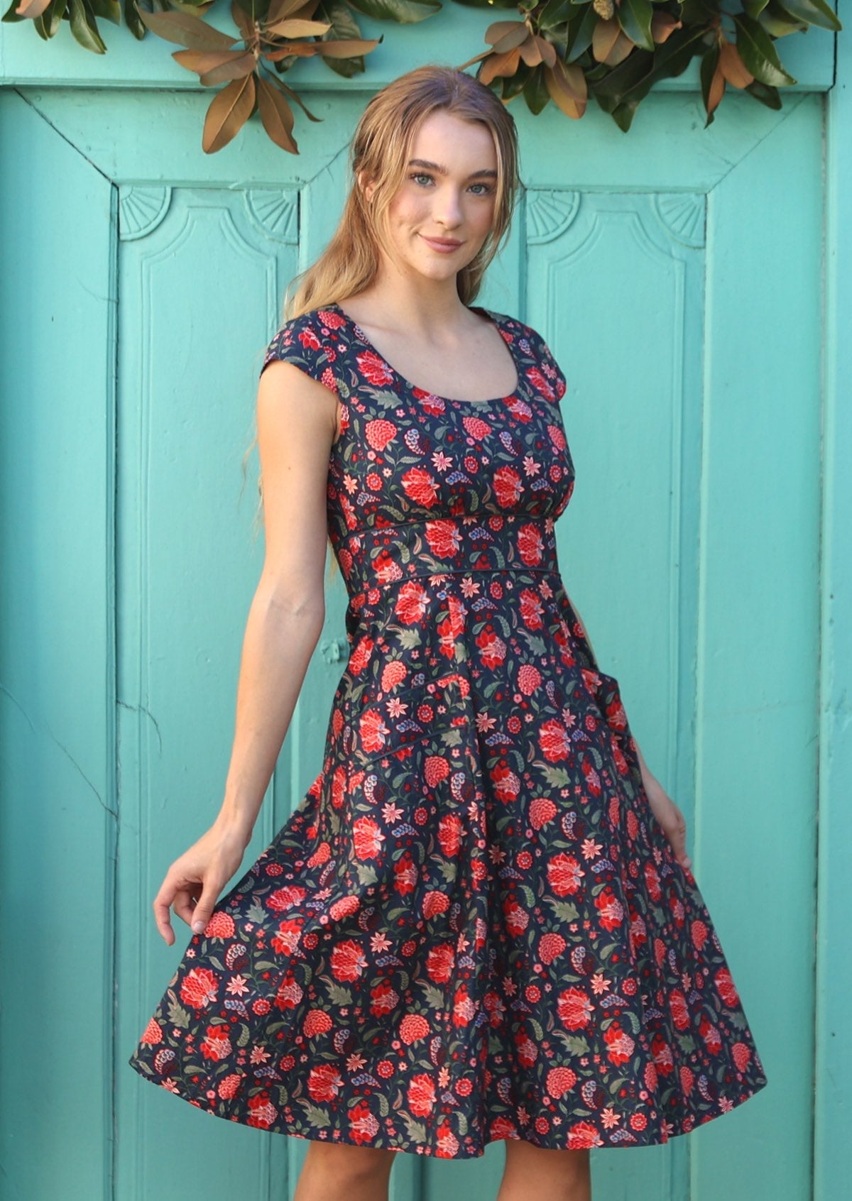 Retro style knee length cotton dress with piped details on waistband and pockets.
