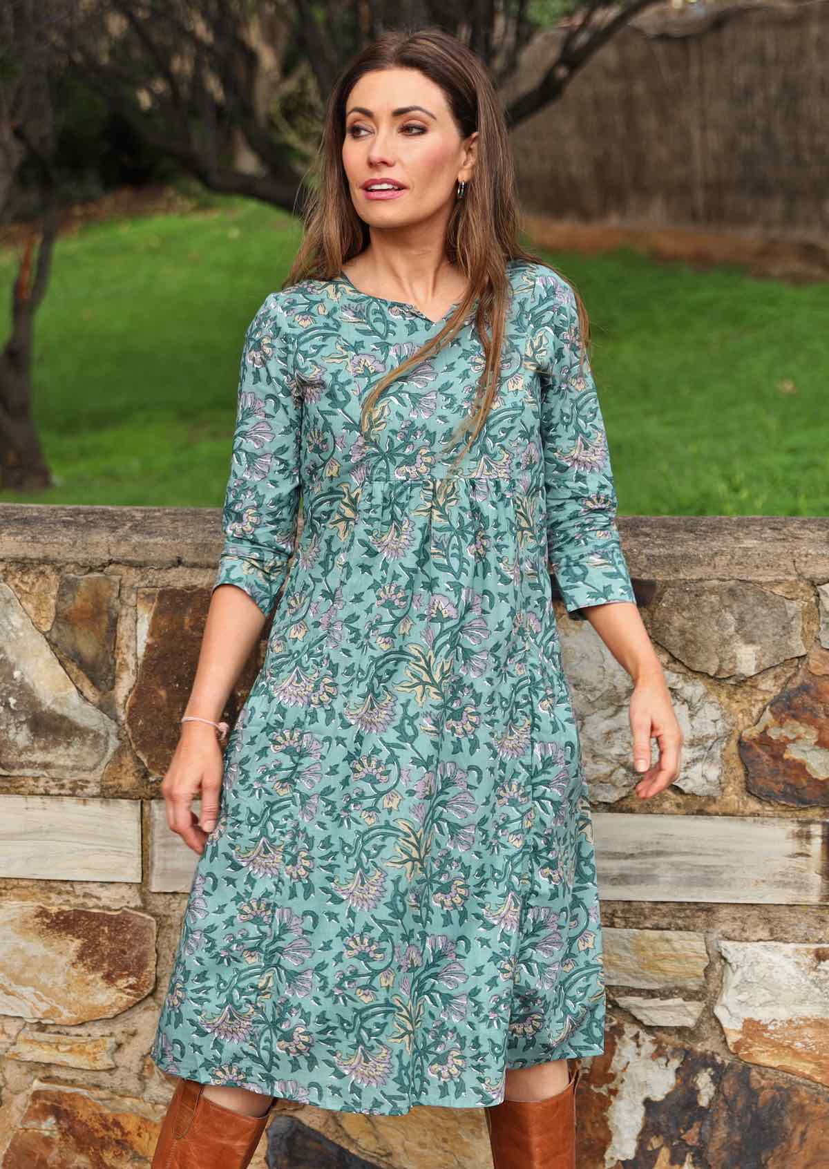 Model wearing 100% cotton dress with beautiful floral print in green tones.