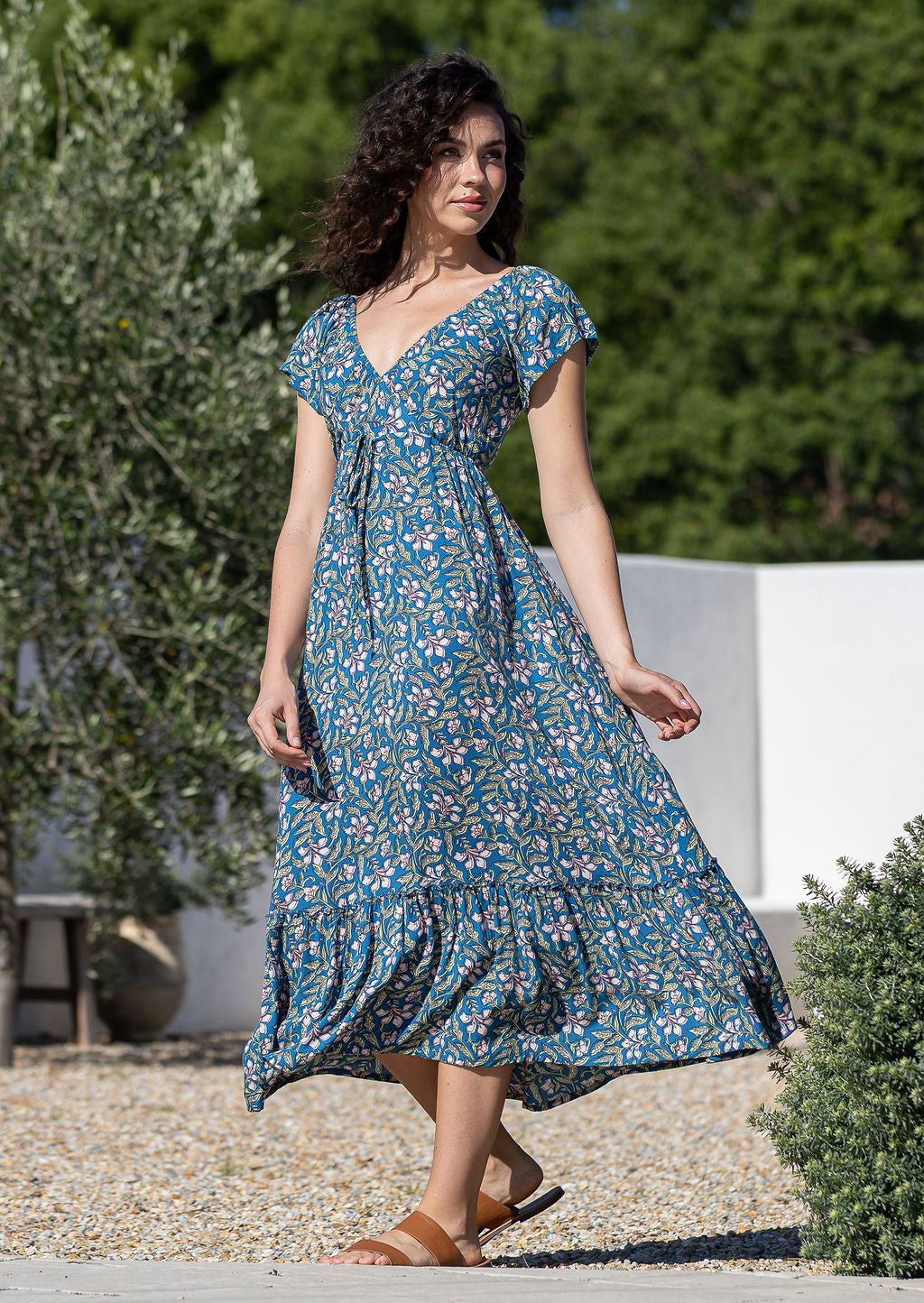 Model wearing 100 percent rayon maxi dress with short sleeves and drawstring waist.