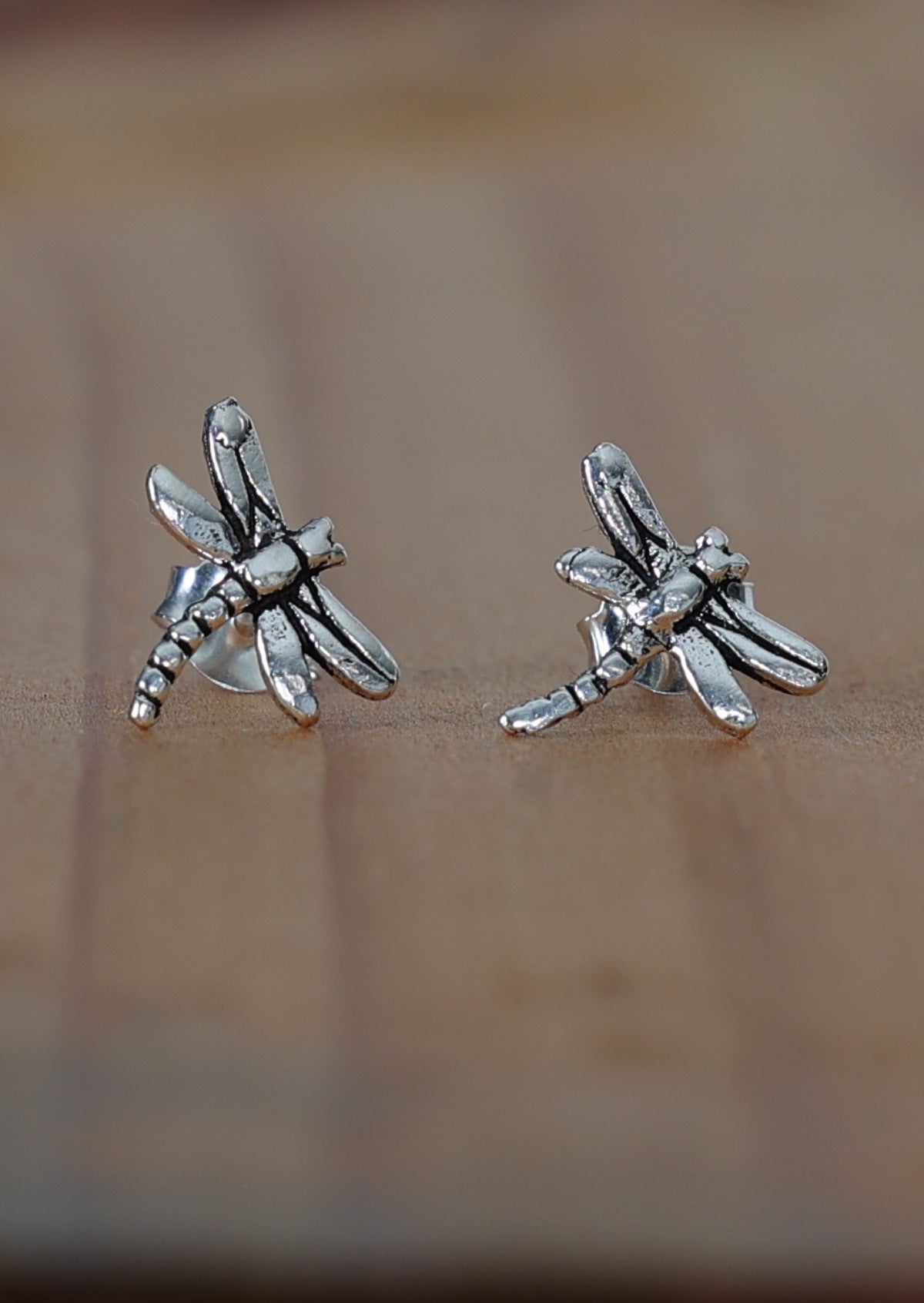 Sterling silver dragonfly studs curving in opposite directions