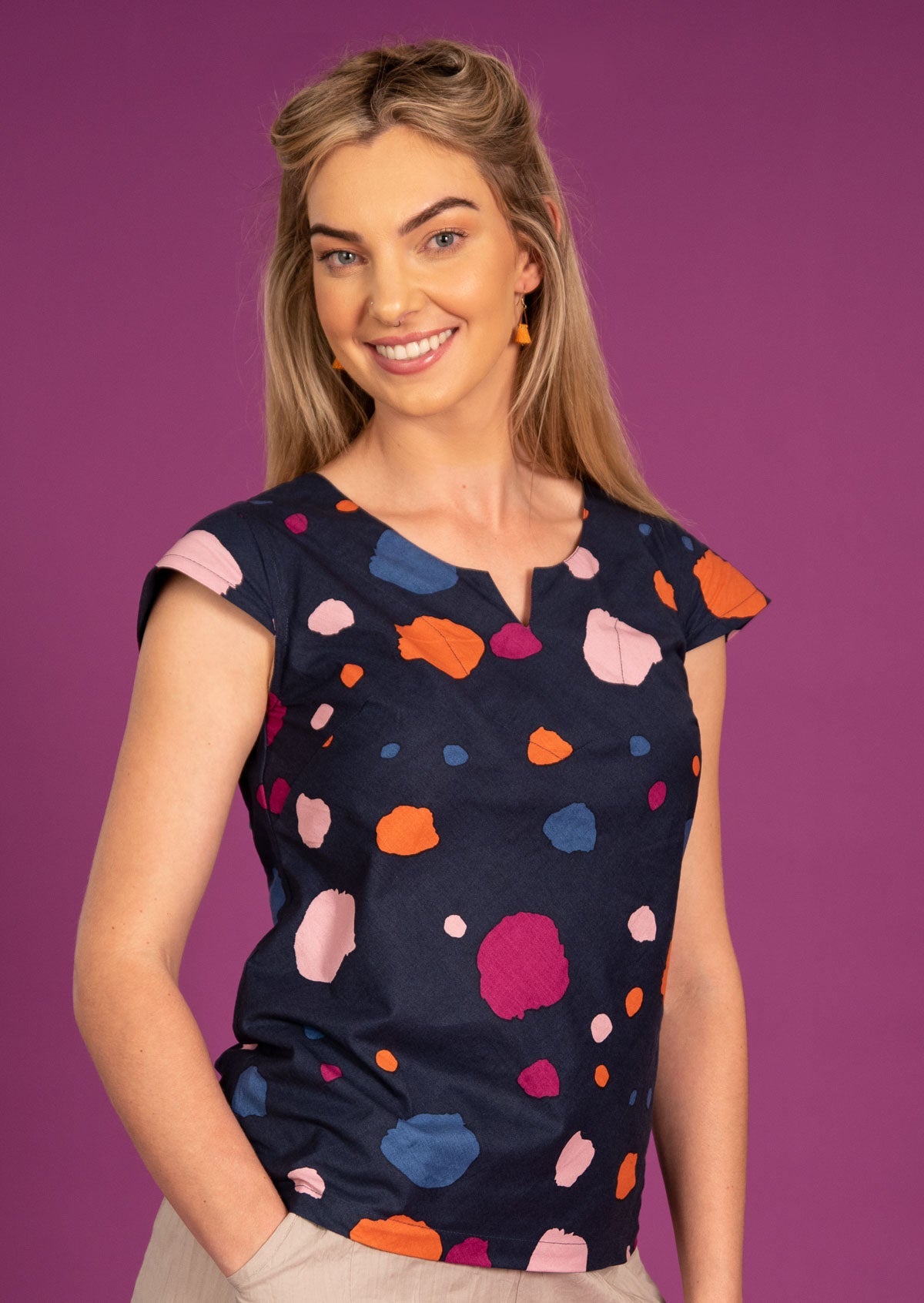 Model wears 100% cotton top with round neckline and keyhole detail, cap sleeves in a navy base coloured spots print