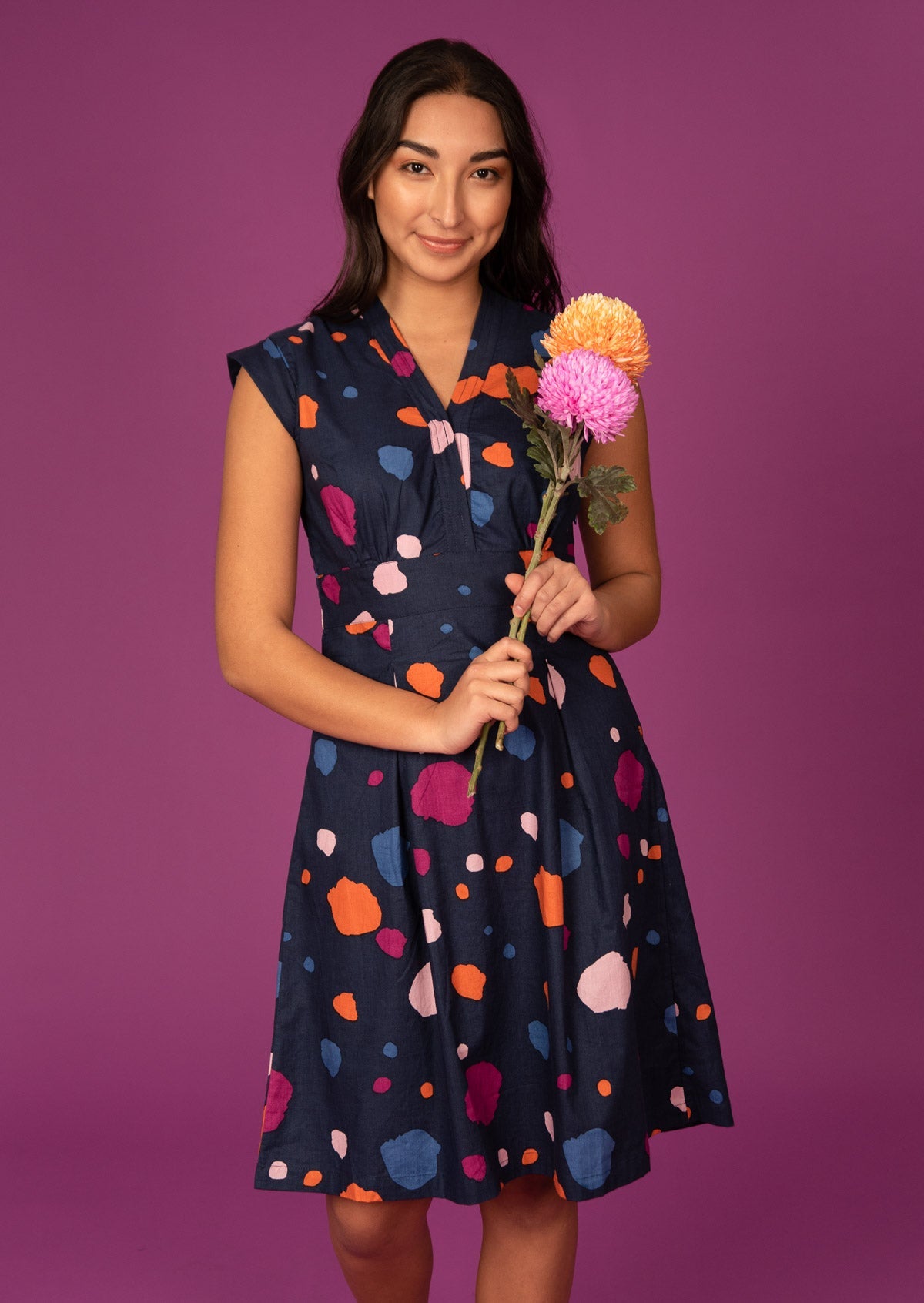 Woman wears A-line Navy and multi coloured spotty print Cotton Womens above knee Dress