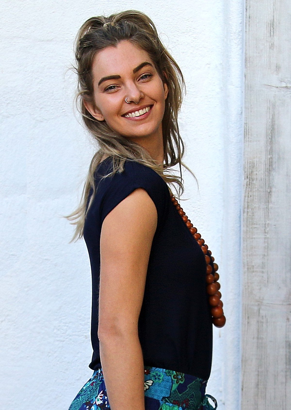 Side view of woman wearing a soft flattering fit navy blue rayon jersey t-shirt.