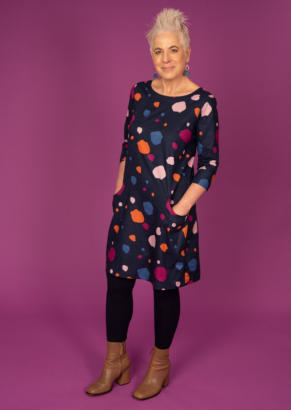 Knee length cotton dress in colourful spotted print paired with leggings and boots.