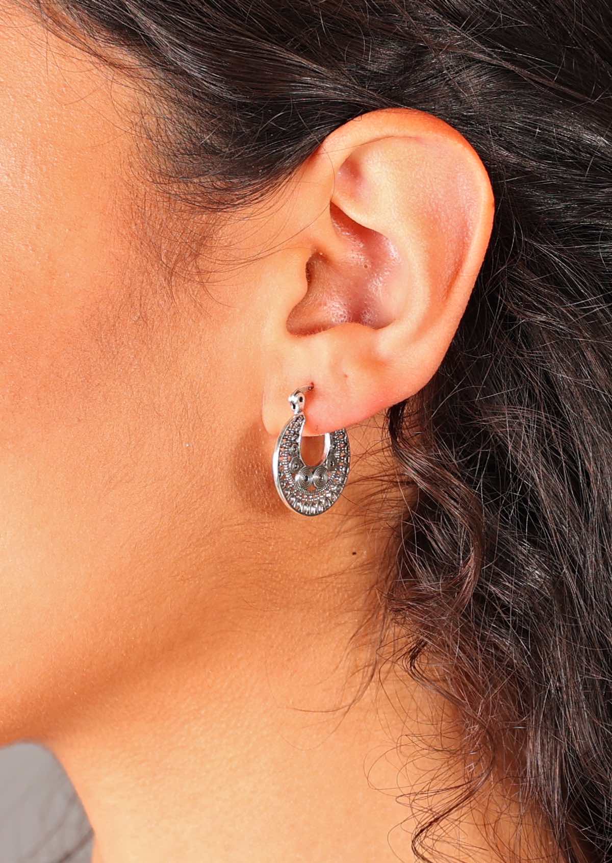Silver flat disc earrings with fine spiral details in a radiating mandala pattern, and a hinged clasp