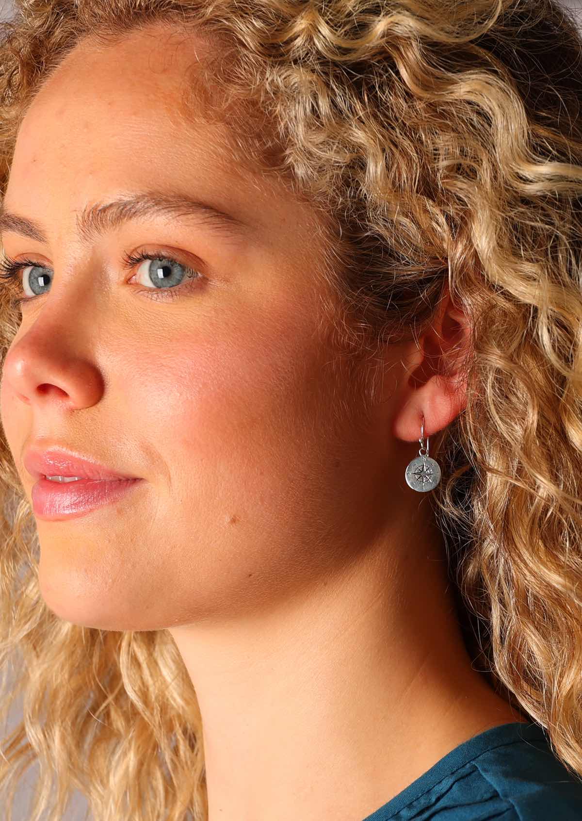 Sweet compass etched into the surface of the sterling silver disc earrings