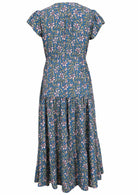 Back view of blue based block style floral print rayon short sleeve dress with pockets.