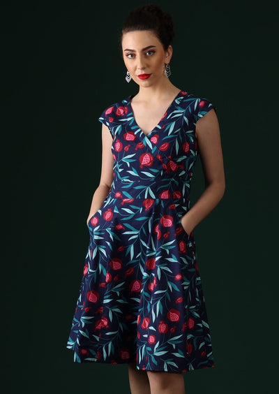Model wears retro style dress with fruit print.