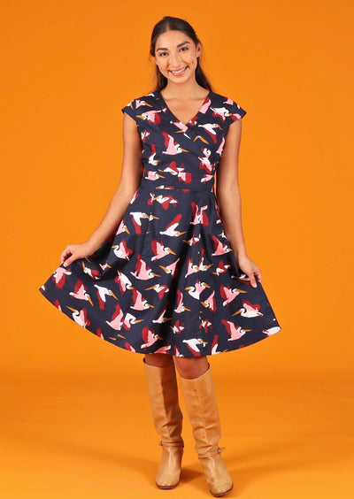 Woman wearing v-neck crossover bodice cotton dress