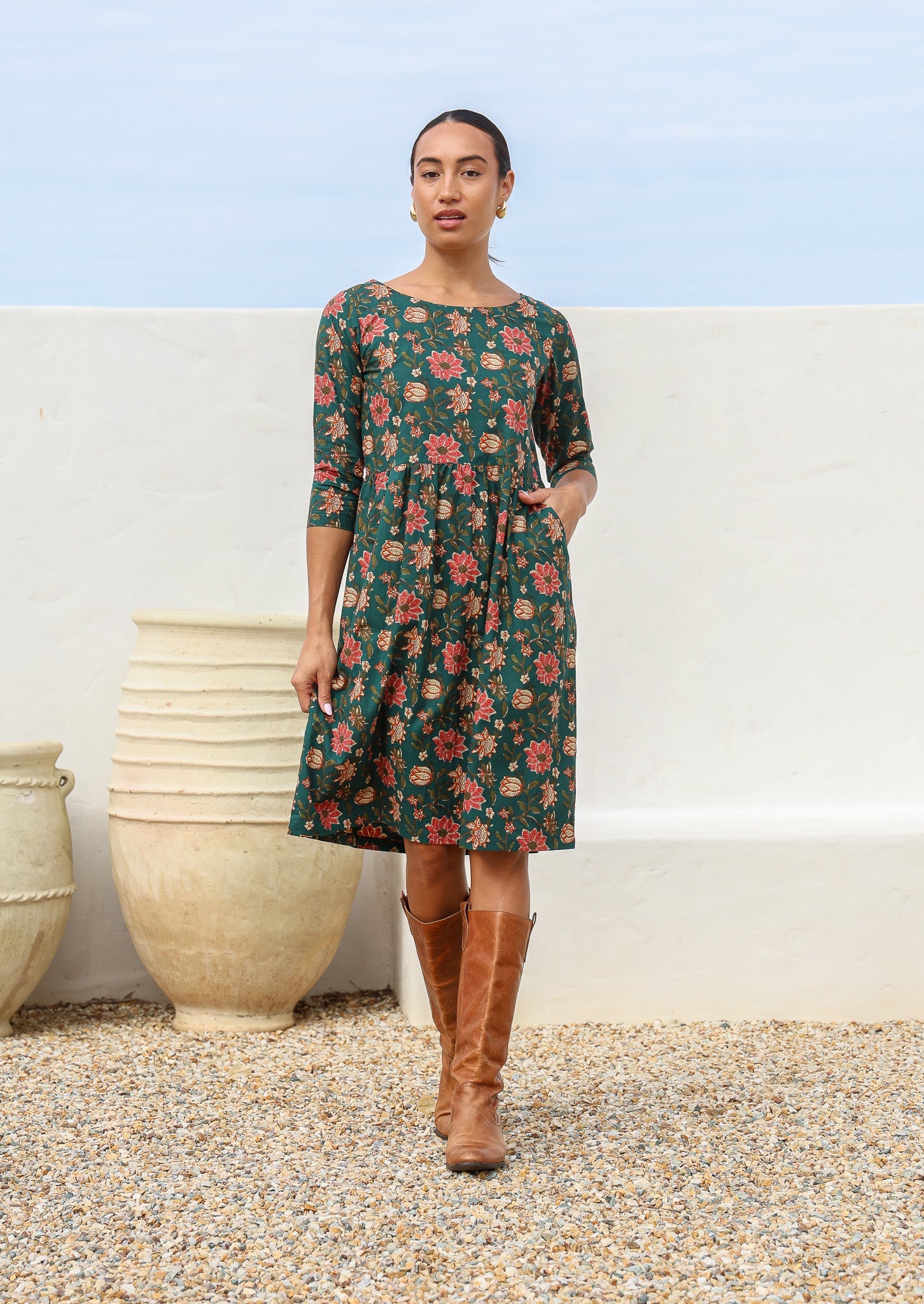 100% cotton knee length dress in deep green with empire waistline, pockets and 3/4 sleeves.