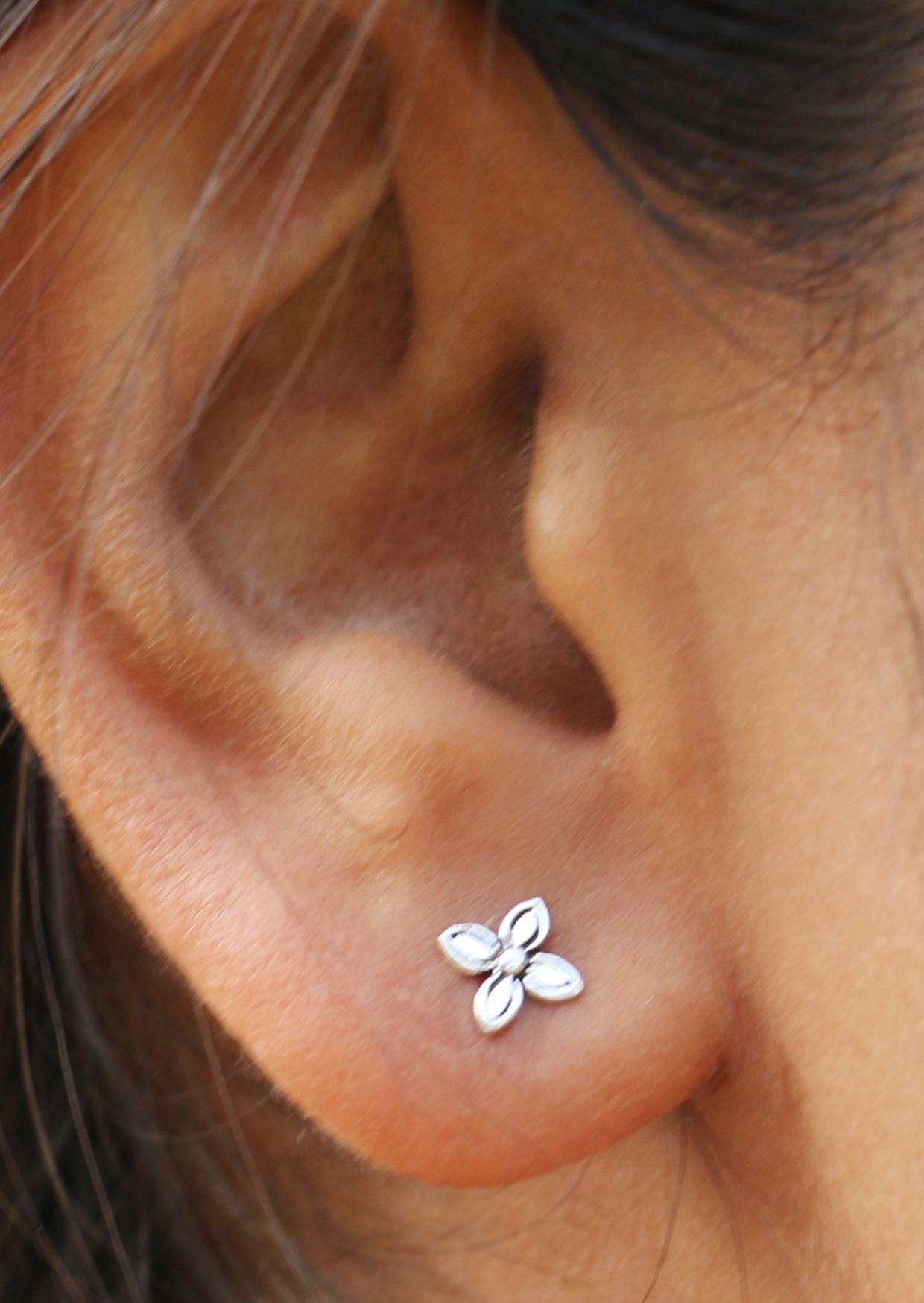 Elegant sterling silver Baronia Studs featuring a symmetrical four petal leaf design with a polished finish