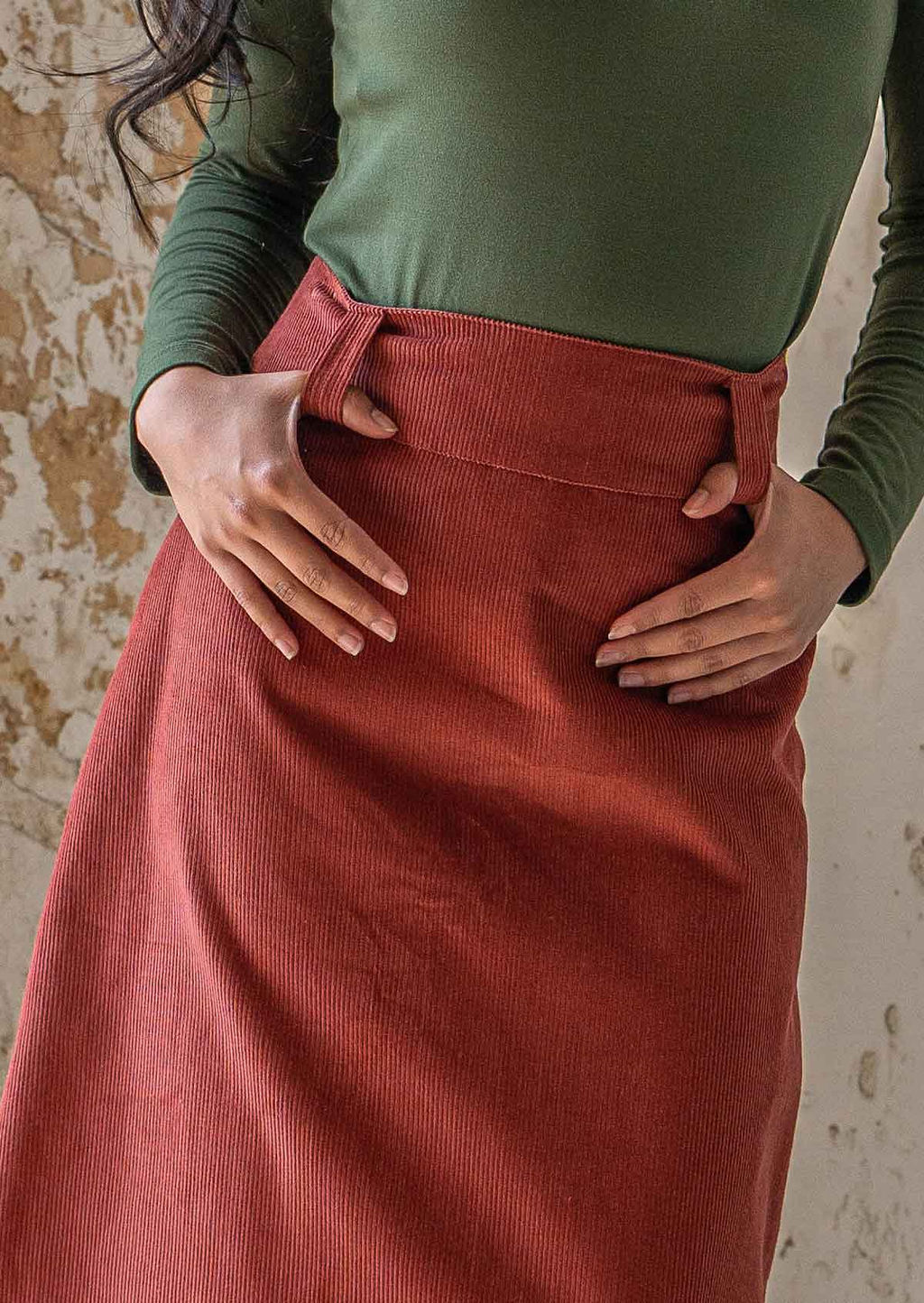 Close up of belt loops on burnt henna coloured corduroy skirt