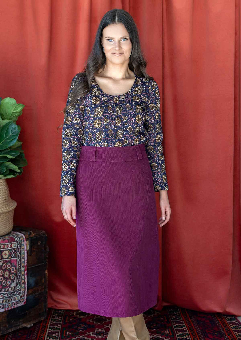woman wearing purple corduroy skirt with cotton top