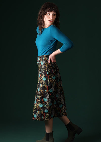 Model wears A-line midi skirt with back pockets