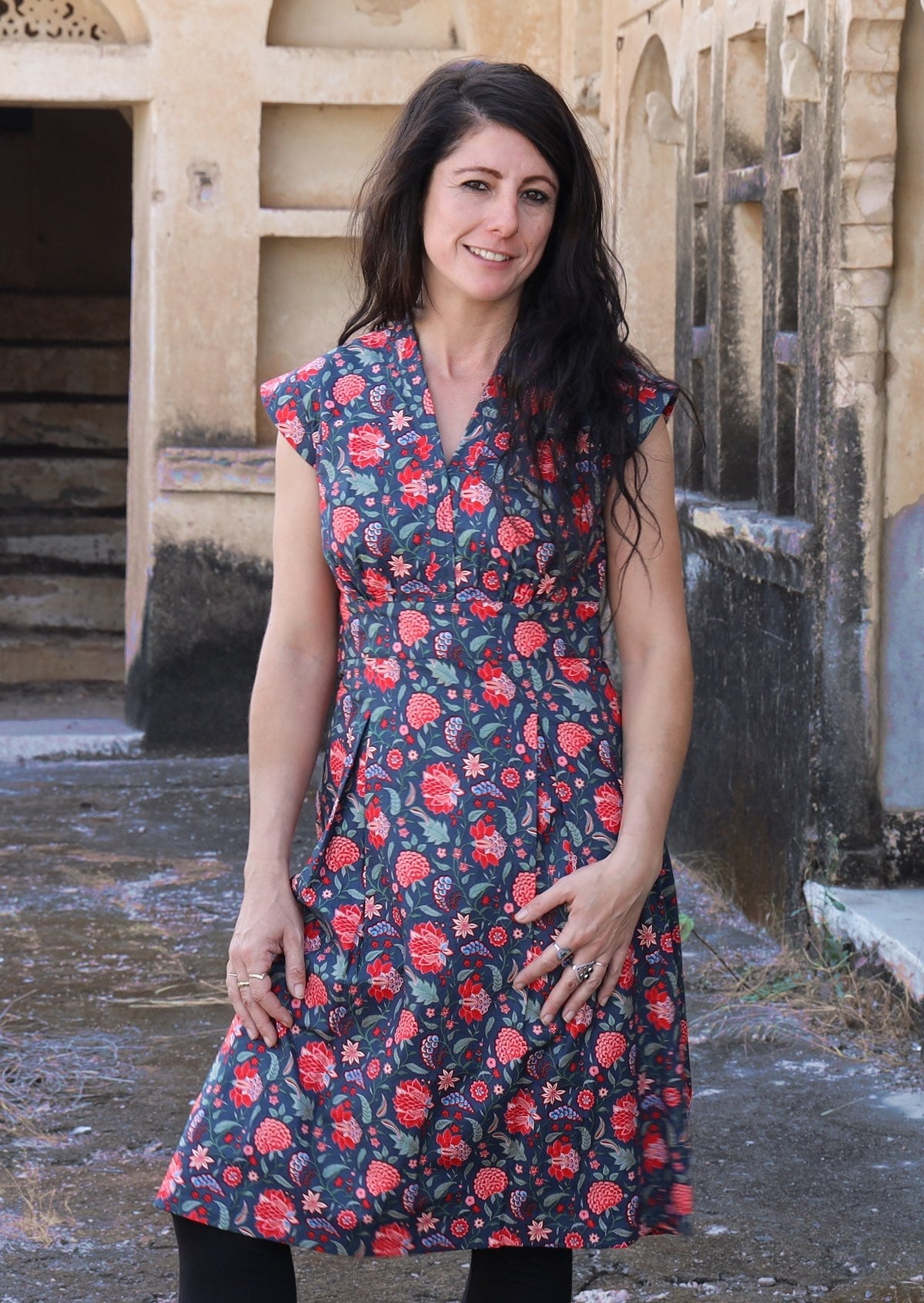 Model wearing deep navy blue based floral cotton retro style dress with cap sleeves