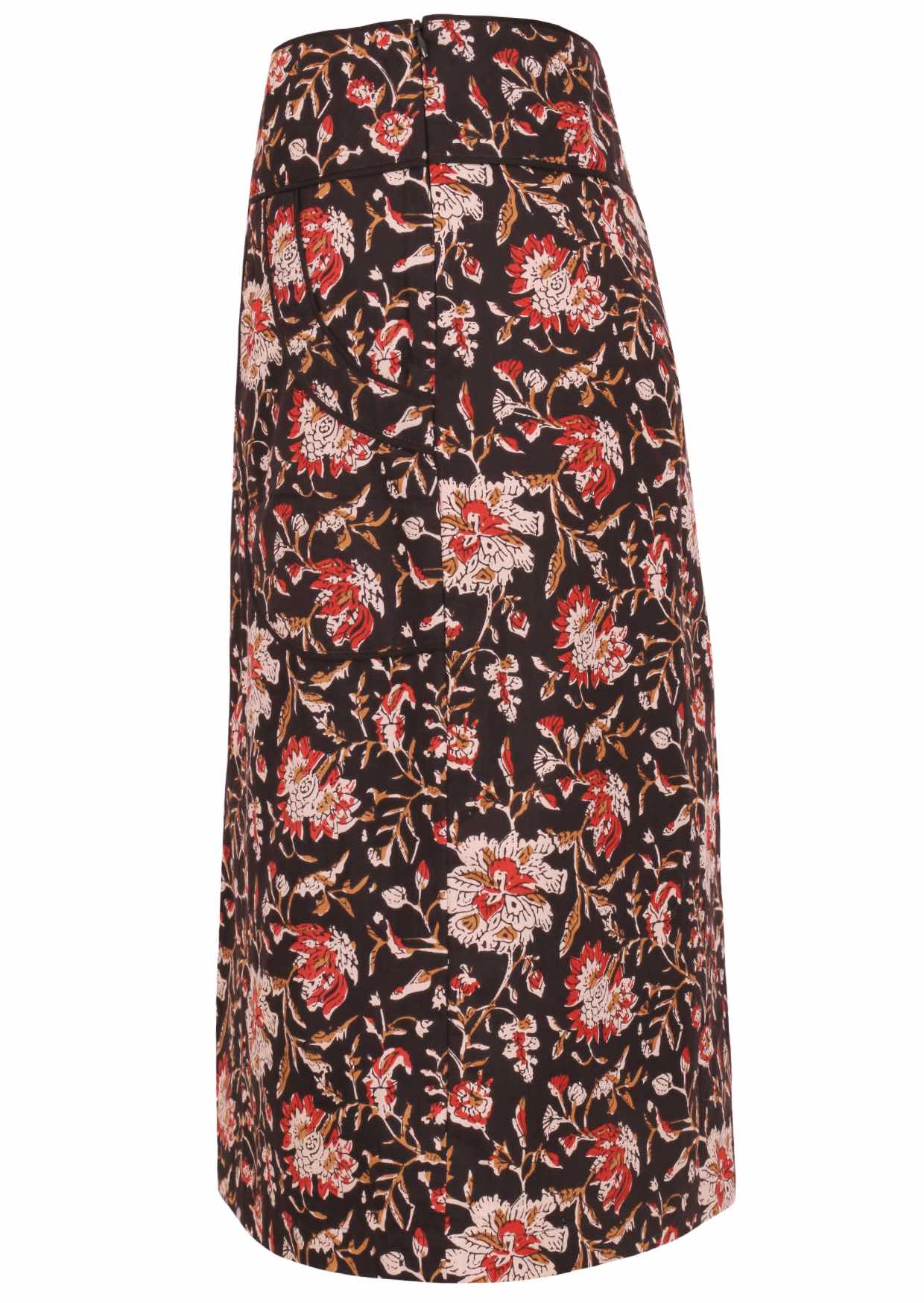 Side view of knee-length cotton pencil skirt with side zipper and piped details in traditional Indian print in rust, tan and sand on a black base.