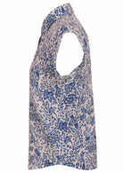 White based blue floral print cotton shirt on a mannequin against a white background