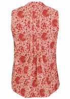Back view of cream based floral print sleeveless top with flared hem and vertical decorative pleats at the center of the back 
