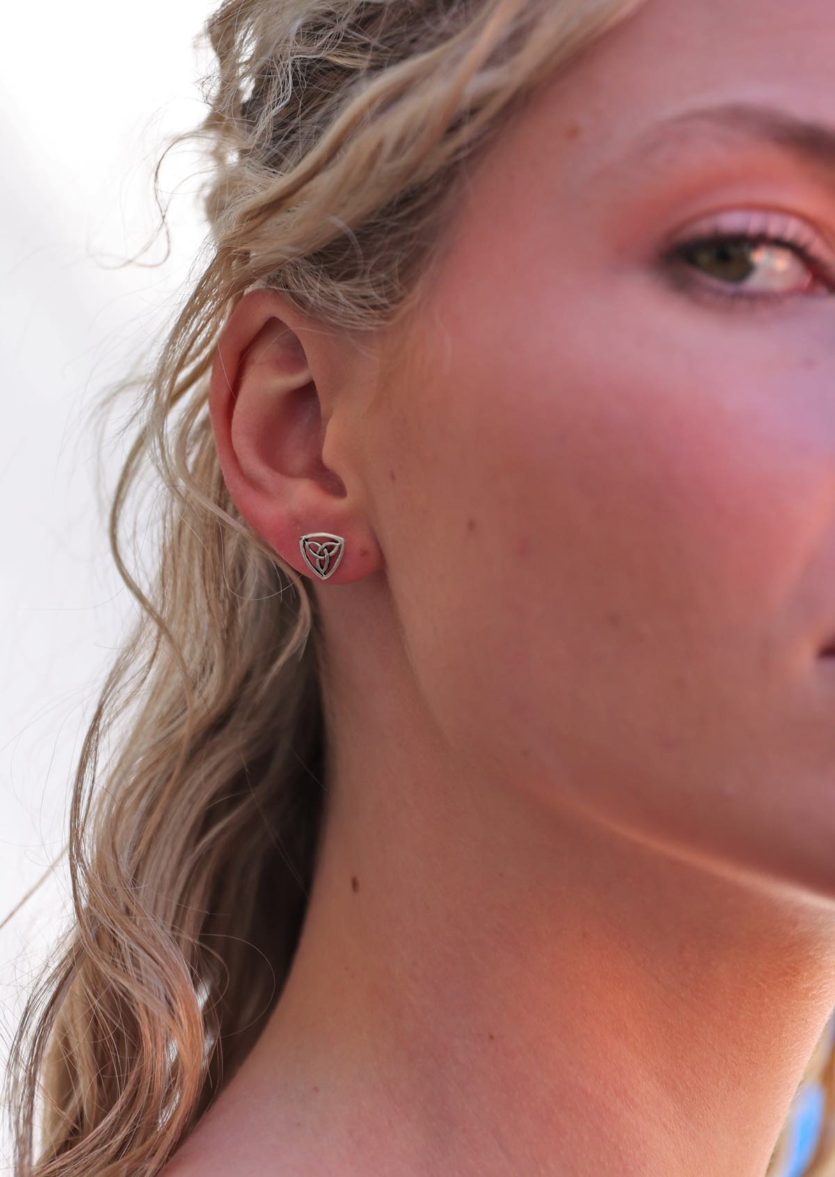 woman wearing sterling silver Celtic Triangle stud earring 