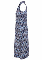 Sleeveless cotton, collared dress with button through front, pockets and gathers under the bust in navy blue based floral print