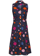Sleeveless, button through dress with collar, gathers under the bust and pockets in navy based colorful spot print.