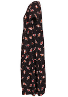 Side view of cotton short sleeved midi length dress with empire waist and tiered skirt in black based floral print 